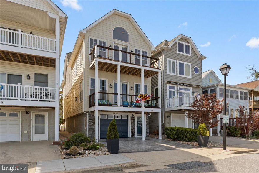 Sophisticated Chesapeake Bay Waterfront Living with unmistakable Architectural Digest vibes. Imagine waking each morning to breathtaking sunrises shimmering across the Bay, all less than an hour from both Washington, D.C. and Annapolis. Perfectly positioned in the heart of North Beach, this exceptional residence offers walkability to the boardwalk, fishing pier, nature parks, community beach, boutique shopping, restaurants, farmers markets, coffee shops, and local favorites for ice cream on warm summer evenings.

Meticulously maintained and thoughtfully designed, this custom waterfront retreat delivers refined coastal living with extraordinary attention to detail throughout. Expansive windows frame panoramic Chesapeake Bay views while the soothing sounds of the shoreline and migratory birds resting during their flights up and down the Atlantic Seaboard create a sense of serenity in nearly every room.

The main living level was designed for both elevated entertaining and relaxed everyday living, featuring a stunning waterfront deck, cozy fireplace, and a gourmet kitchen that will inspire even the most discerning chef. Premium appliances, generous pantry space, and sweeping water views transform cooking into an experience of its own. Multiple outdoor living spaces—including a screened porch, lower-level entertaining area ideal for grilling, and an incredible rooftop deck—offer endless opportunities to unwind or host unforgettable gatherings under the stars.

The luxurious primary suite is a private sanctuary overlooking the Bay, complete with its own waterfront deck for peaceful mornings or evenings spent watching the moonlight dance across the water. The home offers three spacious bedrooms plus a charming fourth-level hideaway perfect for guests, a reading retreat, creative studio, a fourth bedroom, or meditation space. Thoughtful architectural touches such as window seating, soaring 9'+ ceilings, rich hardwood flooring, designer fixtures, high-end windows and doors, and fresh interior paint elevate the home’s timeless aesthetic.

Unlike many waterfront homes, practicality meets luxury with a rare traverse tandem garage accommodating up to three vehicles or a boat along with abundant storage space. Built with quality craftsmanship and exceptional care, this turnkey property offers peace of mind as well as beauty.
Whether you are searching for a full-time waterfront lifestyle or the ultimate weekend escape, this is a rare opportunity to experience the very best of Chesapeake Bay living—just in time to enjoy North Beach’s spectacular Fourth of July celebrations from your own coastal retreat. Life is short. Live where every day feels like a vacation.