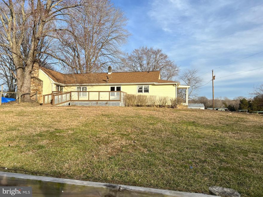 PRICE REDUCED!  3 Acres in the country!  Nice front yard with deck and mostly fenced.  This home offers ramps into the front door and deck (unknown if ADA compliant).  One level living with a stone fireplace that is the center piece of the livingroom and hardwood floors throughout.  2 refrigerators included (icemaker does not work), A/C unit is 6 years old, plenty of yard for a beautiful garden or animals.  Gutters are new and have gutter guards (no more climbing on ladders every fall!)  Renovate this home to restore it to pristine condition or build a new home on the property. Home being sold AS-IS.