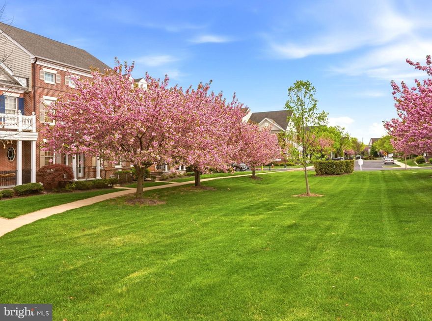 This Newtown Walk luxury townhome offers modern amenities and fantastic space within a quiet courtyard setting, just outside a historic borough. Situated within walking distance to boutique shops, top-rated dining, and entertainment in Bucks County’s acclaimed Newtown Borough, this 4-bedroom residence features Federalist-style architecture with brick and Hardie Plank exteriors thoughtfully designed to complement the surroundings. A walkway bordered by beautiful cherry trees leads to picturesque courtyard views that support a private, low-maintenance lifestyle. The interior comprises three levels of well-appointed living space. The main floor presents an open-concept layout, generously sized rooms, nine-foot ceilings, hardwood floors, stunning moldings, and access to a private deck with privacy screen and garden. The adjacent family room includes a gas fireplace and built-in shelving, enhancing both comfort and entertainment potential. The kitchen is equipped with cherry cabinetry, granite countertops, spacious multi-tier island, stainless steel appliances, double sink, and breakfast nook. Additional features on this level include a half bath and a convenient laundry/mud room. The upper-level primary suite is a wonderful retreat with glistening hardwood floors, two generous walk-in closets and a newly renovated spa-inspired bath featuring dual marble vanities, radiant heat flooring, heated towel rack, water closet, and beautiful walk-in shower. Two additional bedrooms share a full hall bath and feature gleaming hardwood flooring and sun kissed space. The third level offers wonderful flexibility with a living area, bedroom, and full bath, suitable for guests, a home office, or space to play. The lower level allows for customization, with the ability to add further living space, sleeping space and a full bathroom if desired. Additional amenities include a two-car garage, new air conditioning, Trek deck, newer two-zone heating and cooling system, fresh paint, and ample storage. The homeowners’ association helps navigate a low maintenance lifestyle and covers common area maintenance, exterior upkeep, trash collection, and snow removal. Located on a premium lot adjacent to Roberts Ridge park within the award-winning Council Rock School District, this property offers convenient access to trains, the I-295 corridor for easy travel to Philadelphia, Princeton and New York and the suitability and charm that Newtown has to offer.