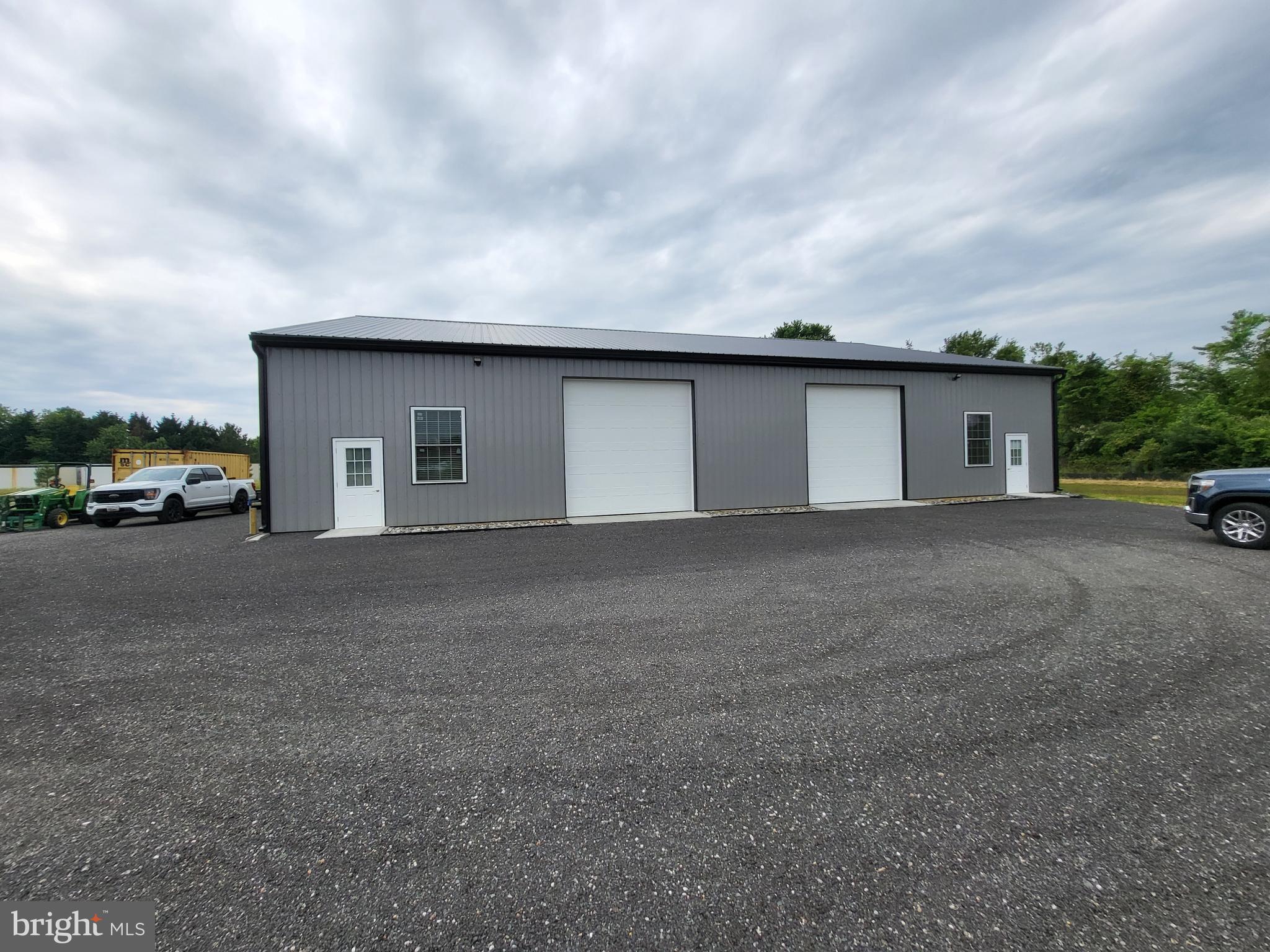 Brand new never occupied 4,800+/- square foot building that can be one or two units. Located in an Industrial Park in Dorchester County but not in the city limits of Cambridge. Well water but the advantage of a connection to the sanitary public sewer. The building is insulated with two overhead doors, two bathrooms with showers, two entry doors and each side is separately metered. 15 foot ceilings with easy access make this an attractive property to operate your business and potentially rent out one side.