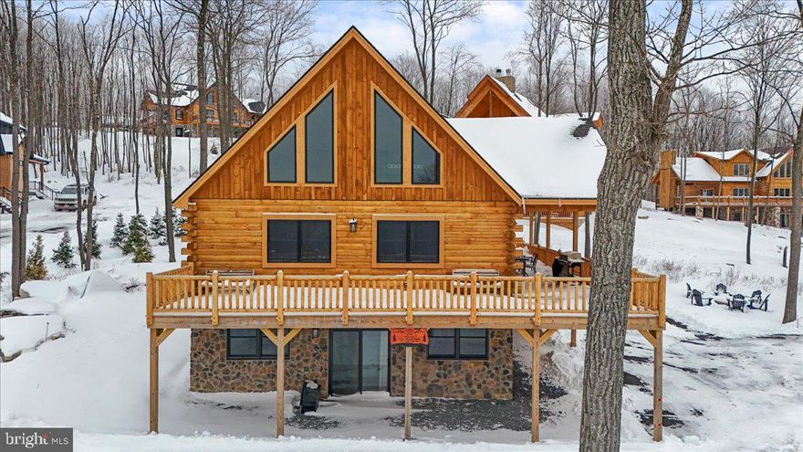 “Mystic Mountain Manor” is an income-producing vacation rental located minutes from Wisp Resort, Lodestone Golf Course, and Deep Creek Lake. This 5-bedroom, 5.5-bath stone and log chalet offers 3,283 finished square feet and sits on a beautiful ½-acre lot in one of the area’s strongest four-season rental corridors.

Designed with short-term rental performance in mind, the layout features five ensuite bedrooms, an oversized loft, and a fully finished walk-out basement with a second living area and game room with a pool table. The open-concept main level includes a two-story great room with a stacked stone gas fireplace, stainless steel appliances, granite countertops, hardwood cabinetry, and bar seating. Wrap-around deck and hot tub enhance guest appeal.

Built in 2023 with upgraded LVP flooring, granite in all baths, custom lighting, and quality finishes throughout, this property offers the benefit of newer construction with minimal deferred maintenance. Sold fully furnished and operating as an established vacation rental with an average daily rental of $343 and a projected gross annual rental income of $47k to $52k.

Membership in The Wisp Resort Master Association – Lakeside Park conveys access to a 1.94-acre waterfront parcel with 170 feet of Deep Creek Lake frontage, pavilion, lake-view seating platform, restrooms, walking trails, and parking.

Turnkey opportunity in a proven Deep Creek Lake location.