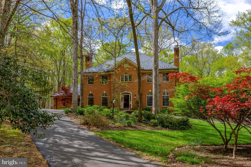 Welcome to your private country retreat!
Tucked away at the end of a quiet lane, this beautiful all-brick home offers peace, privacy, and space to relax. Surrounded by nature and set on six serene acres, the property features a circular driveway, lush landscaping, and multiple outdoor living areas including a two-level deck, brick patio, hot tub, and fire pit—perfect for entertaining or unwinding in the fresh air.

Crafted with exceptional attention to detail, the home boasts extensive millwork throughout, a slate roof with copper gutters, and a timeless elegance that’s both warm and refined.

Inside, elegance and comfort abound. The main level features a marble foyer with wainscoting and crown molding, a beautifully appointed living room with a marble fireplace, and a gourmet kitchen with cherry cabinetry, granite countertops, and a cozy bay window breakfast nook. Host gatherings in the formal dining room with triple crown molding, or retreat to the oak-paneled library with a wood-burning fireplace. The warm family room, complete with stone fireplace and French doors to the deck, adds charm and functionality. A stylish powder room and well-equipped laundry room complete the main level.

Upstairs, the expansive owner’s suite boasts a fireplace, tray ceiling, dual walk-in closets, and a stunning spa bath with marble tile, freestanding tub, and mosaic accents. Three additional bedrooms—one with ensuite bath—offer ample space, all with hardwood floors.

The finished lower level impresses with a grand recreation room, potential fifth bedroom, exercise room with sauna and wet bar, wine cellar, full marble bathroom, and abundant storage.

Enjoy peace of mind with a whole-house generator and a sense of true escape in this exquisite, nature-surrounded property—where luxury craftsmanship meets tranquil country living.