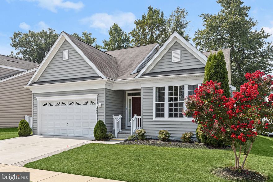 Discover your dream home in the resort-style WATER privileged Creekside at Osprey Landing community. Enjoy a serene, water-oriented lifestyle in this gated community with convenient access to the marina, canoe and kayak storage, a nature trail, and an inviting community center complete with a furnished deck, gathering room, and exercise room. Nestled on a prime corner lot with irrigation system, this stunning 3-bedroom, 3.5-bath home boasts an open concept living area, combining the living room, dining room, and kitchen. The main level is accentuated by gorgeous hardwood flooring, a neutral color palette, and recessed lighting. Cozy up in the living room, featuring a charming gas fireplace, or entertain guests in the dining room, which offers a bay window and sliding glass door leading to the deck. The gourmet kitchen is a home chef's dream, showcasing granite countertops, a tile backsplash, modern cabinetry with roll-out shelves, a spacious island with a breakfast bar, stainless steel appliances, and a pantry for extra storage. A den or study with a cathedral ceiling sits adjacent to the living room, while the main level primary bedroom provides deck access, a walk-in closet, and an en-suite bath with a double vanity and large shower with a bench. The upper level houses two additional bedrooms, a full bath, and a loft. Retreat to the lower level to enjoy the family room, bonus room, and another full bath- allowing for endless possibilities to suit your lifestyle needs.   The lower level also offers a storage room and utility room with storage space. An attached 2 car garage, driveway, and guest parking throughout the community ensures convenient parking for all. Finally, unwind in the beautiful outdoors on the large composite deck, or take in the natural beauty of the surrounding trees in the backyard. This ideal location provides convenient access to I-97, MD-2, and MD-100 for shopping, dining, entertainment, and everyday necessities. Don't miss this incredible opportunity to call this exceptional house your forever home. Property Updates: Gutter Helmet (2019), irrigation system (2018), and Ring doorbell.