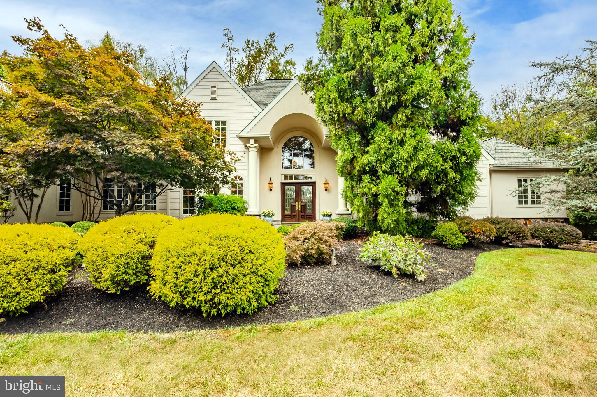 The best of everything! Welcome to 820 Harriton, a custom built home by E.B. Mahoney, which has been loved and exceptionally cared for by the original owners. This custom Main Line treasure features luxurious materials throughout, has an extremely versatile floor plan,
depending on your needs and sits on a 1.8 acre lot in the heart of Lower Merion, one of the highest rated school districts in Pennsylvania. This spacious 5 bedroom, 4 full, 1 half bath home offers everything you’ll ever need and the location cannot be beat. Pull in and immediately admire this gorgeous French style home, the lush and mature landscape and the nice setback off the road. This home definitely has a presence that can’t be missed and it was built meticulously and intentionally to bring the outdoors in. Out of every window, you have a view of the thoughtful landscape as well as the privacy it offers. The first floor is sprawling and spacious. As you enter the home you will be greeted by the 2 story foyer of course, with marble floors that opens right up to the living room, with its floor to ceiling windows, french doors that lead out to the bluestone patio, a limestone fireplace, recessed lighting, built in bar and enough room to throw a party for 75+. This room is absolutely stunning. To the left of the foyer is the large formal dining room with its floor to ceiling curved windows, French doors and room for a very large dining room set- the perfect space to accommodate holidays and gatherings. The kitchen of the home is exceptionally laid out. Gorgeous cream cabinets, a center island, a gorgeous natural stone backsplash, oak hardwood floors, a circular breakfast room, top of the line appliances to include a sub zero, plenty of task lighting, a prep sink and french doors leading out to the back patio, which is perfect for your Summer entertaining. Off the kitchen is a multi purpose room offering a walk- in pantry, laundry area with tons of storage and plenty of prep space for parties. The study of the home boasts gorgeous cherry woodwork with custom cabinetry, shelving and fireplace. This makes the perfect den, playroom, office or sitting room. The primary bedroom is on the first floor and has 2 full baths, both with high end Italian Marble, dual walk-in closets, room for an office space if needed and French doors leading out back as well. The entire back of the home offers access to the gorgeous patio and backyard. There is a bonus room on the first floor that can be used as a 5th bedroom, office, playroom, etc. Head up the grand staircase and you’ll find 3 more bedrooms with ample closet space, 2 full baths and an abundance of attic space- that can be easily finished. There is a very large loft above the garage as well as an additional attic space. These spaces offer you complete versatility for the future. A home office with access from the garage- you have that option here. The walk-out lower level of the home adds incredible square footage! This space isn’t “below grade” so you don’t feel like you’re in the lower level! The finished rec room adds over 1,000 square feet. The unfinished basement space is massive. With over 6,500 square feet, there are endless ways you can live and enjoy this home. There are 2 driveways! One for you with easy access into the garage and one for your guests, with an EP Henry paver walkway, leading to the front door. The oversized 4 car garage is another perk! What makes this home stand out from the crowd is its history and ownership. The love and attention to detail that was incorporated into the construction of this home and then the care over the past 20+ years is what makes it such a wonderful value. Minutes away from some of the best shopping and dining around, Suburban Square, downtown Bryn Mawr, local universities and endless opportunities to enjoy nature trails and parks. Close proximity to all things Main Line.
