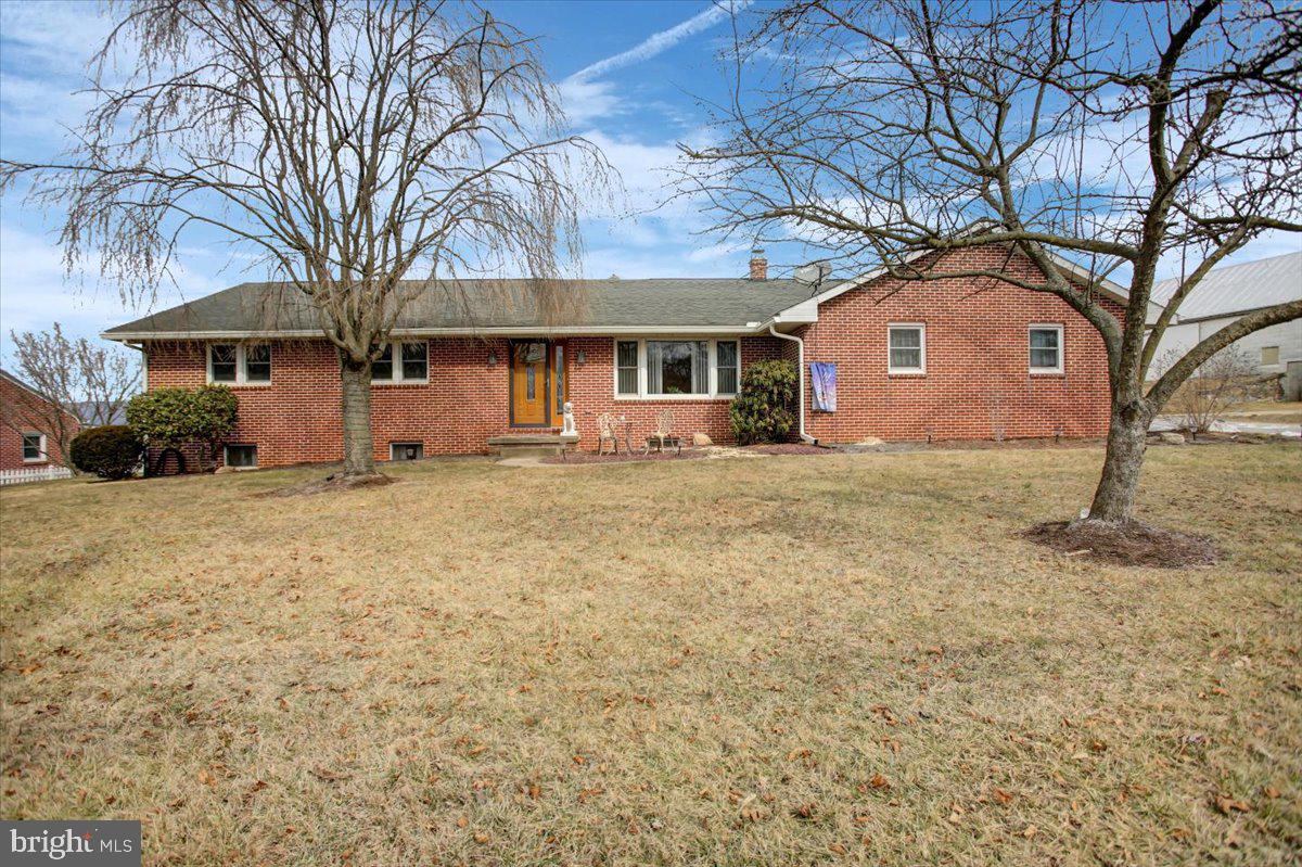 Welcome to this inviting 4-bedroom, 2-full bath ranch home, nestled in a peaceful country setting with breathtaking mountain and farm field views. Perfectly blending comfort and convenience, this home features a traditional floor plan with a spacious kitchen and dining combo, complete with a pantry for all your storage needs.  Enjoy easy access to the outdoors with a brand-new patio (installed in 2021) – ideal for entertaining or simply soaking in the tranquil surroundings. The home also offers a main-floor laundry for added convenience, making everyday living a breeze. The home is equipped with an attached 2-car garage and a detached 2-car garage, providing ample space for vehicles, storage, or hobbies. The partially finished basement offers even more possibilities, whether you’re looking for additional living space, a recreation area, or a home gym.
Recent upgrades ensure that this home is move-in ready:
- New laminate flooring (2024)
- New hot water heater (2024)
- New garage door (2022)
- Underground dog fence (2020)
Included in the sale is an 8-person hot tub, perfect for relaxing under the stars. Please note that the hot tub does need a new motor, estimated at $500, but once repaired, it will be the ultimate addition to your outdoor space. Don’t miss the opportunity to make this peaceful retreat your own. Schedule your showing today!