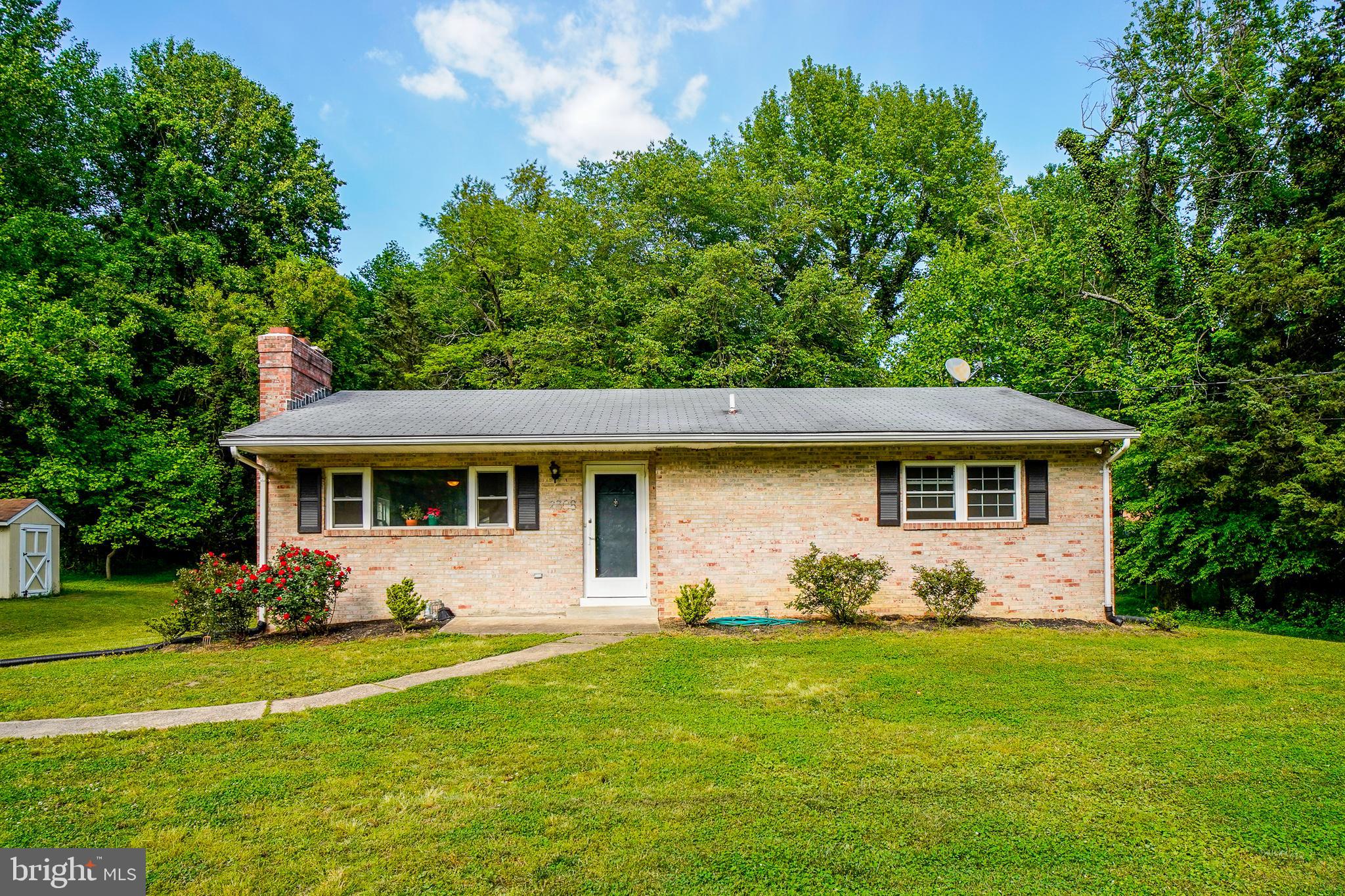Adorable renovated brick rambler nestled in a cul-de-sac in sought after Brock Hall Manor! New kitchen and baths, separate dining and living room with cozy wood burning fire place. Main level primary bedroom with en suite bathroom, Enclosed porch in rear. Unfinished basement with high ceilings and fire place waiting for your vision. One acre lot with large, level private yard backing to woods plus 2 sheds. Great location, minutes to parks and shopping!