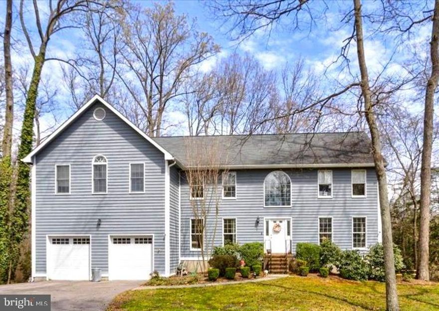 Come see this pondview home located in the exclusive cul-de-sac of Smuggler's Cove on the private backside of Whitehurst!  Walk into your two-story foyer on the main level which has a formal living room, dining room, separate office/den,  large family room with fireplace and a newly renovated gourmet kitchen with center island, granite counters, hardwood floors and stainless appliances.  You have multiple sliders off the back of the main level leading to a large back deck overlooking trees and the pond which make for a perfect entertaining place!   The lower level has an additional three sliders leading to your covered patio area, at-home gym, wet bar, woodstove, living space and a huge storage area that could be converted to a guest suite or in-law space.  Your upper level offers 4 bedrooms with an owner's suite that has its' own living area, fireplace and private balcony.  You will also love the dual walk-in closets and bonus area.   Kayak rack and access to the pond is right next to you!  With so many extras... this home is worth the visit! The tax record does not include accurate square footage!  Owners are relocating and have their home of choice... so no rent-backs needed... you can move right in!