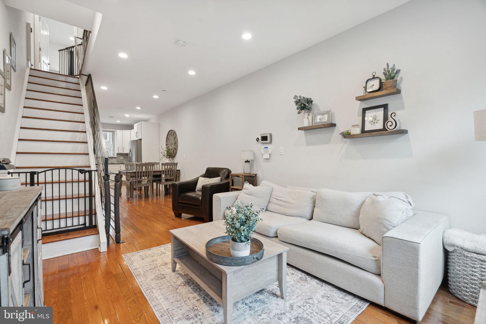 This stunning three-story newer construction home offers 3 bedrooms, 3 full baths, a finished basement, a private fenced-in yard, and a spectacular roof deck with panoramic skyline views. With a Tax Abatement through 2027, this home combines modern luxury with long-term savings. The open-concept layout features a sleek kitchen with polished quartz countertops, a glass tile backsplash, and stainless steel appliances. The second floor includes two spacious bedrooms, a hall bath, and a convenient laundry nook, while the third floor boasts a luxurious primary suite with a large bedroom, dual vanity, and en suite bath. Additional highlights include a NEST thermostat, video intercom system, custom steel stair rails, and central air conditioning. Ideally located with easy parking and quick access to I-95 and public transportation, this home is steps from local favorites like Little Susie’s, Stock’s Bakery, Tacconelli’s Pizza, and the upcoming Delaware River Trail extension. With an 86 Walk Score and 94 Bike Score, this is city living at its best—schedule your showing today! All square footage numbers are approximate and should be verified by the buyer. It is the responsibility of the buyer to verify real estate taxes.