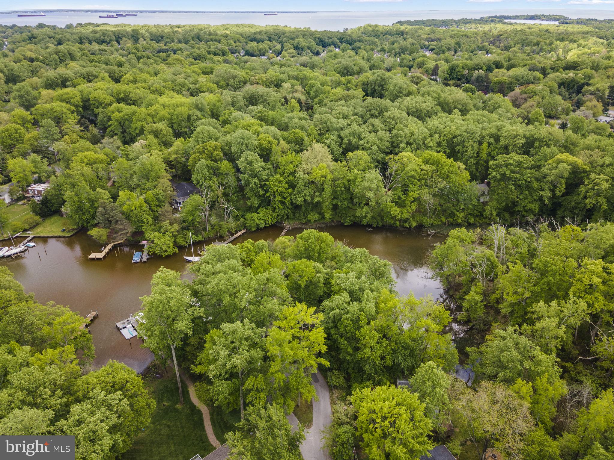 The property at 1009 Dulaney Lane in Annapolis, Maryland, offers a rare opportunity to build a custom waterfront home in the sought-after Annapolis Roads community. Priced at $575,000, this 0.47-acre wooded lot is situated at the end of a quiet cul-de-sac, providing privacy and scenic views of Lake Ogleton. With 137 feet of waterfrontage, the elevated lot allows for the potential to maximize water views throughout the property .
Residents of Annapolis Roads enjoy community amenities such as a private beach, pavilion with fire pit, boat launch, pier, and walking trails. The location offers easy access to the Chesapeake Bay and is just minutes from downtown Annapolis, Eastport, and the U.S. Naval Academy. Commuters will appreciate the proximity to Route 50 and I-97, providing direct routes to Baltimore, BWI Airport, Fort Meade/NSA, and Washington, D.C. .
The lot is connected to public sewer, simplifying the building process. Potential buyers can bring their architect to design a peaceful waterfront retreat that takes full advantage of the natural surroundings and community features .
Lot can be purchased separately for $400,000 or can be combined with 1011 Dulaney for $2,950.000. Engineering has not been done but the lot could be a fabulous accessory dwelling unit (ADU) for this property or an opportunity for additional privacy.