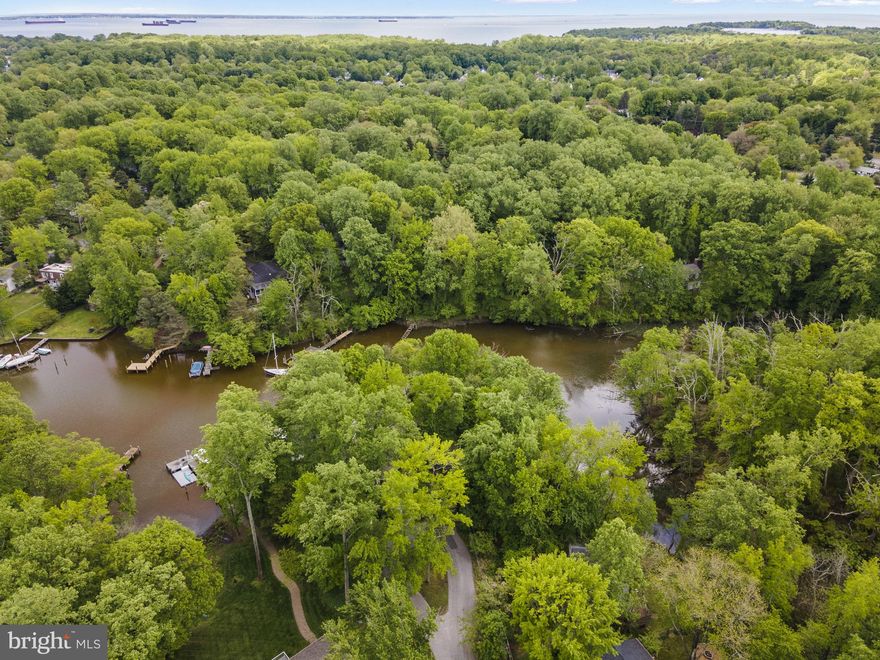 The property at 1009 Dulaney Lane in Annapolis, Maryland, offers a rare opportunity to build a custom waterfront home in the sought-after Annapolis Roads community. Priced at $575,000, this 0.47-acre wooded lot is situated at the end of a quiet cul-de-sac, providing privacy and scenic views of Lake Ogleton. With 137 feet of waterfrontage, the elevated lot allows for the potential to maximize water views throughout the property .
Residents of Annapolis Roads enjoy community amenities such as a private beach, pavilion with fire pit, boat launch, pier, and walking trails. The location offers easy access to the Chesapeake Bay and is just minutes from downtown Annapolis, Eastport, and the U.S. Naval Academy. Commuters will appreciate the proximity to Route 50 and I-97, providing direct routes to Baltimore, BWI Airport, Fort Meade/NSA, and Washington, D.C. .
The lot is connected to public sewer, simplifying the building process. Potential buyers can bring their architect to design a peaceful waterfront retreat that takes full advantage of the natural surroundings and community features .
Lot can be purchased separately for $400,000 or can be combined with 1011 Dulaney for $2,950.000. Engineering has not been done but the lot could be a fabulous accessory dwelling unit (ADU) for this property or an opportunity for additional privacy.