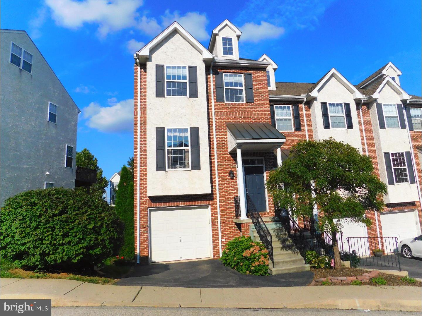 Seller is offering a one year home warranty with purchase! This bright and sunny end unit in the desirable Nathans Place boasts an open floor plan with windows throughout. Enter the home to a large eat in kitchen, complete with granite countertops and tile backsplash. The kitchen opens up to additional seating in the dining area. The first floor features wall to wall glistening hardwood and recessed lighting throughout, with a guest bathroom just off the kitchen. Enjoy quality time with your guests, sitting by the fireplace or on the deck. The perfect floor plan for entertaining! The en suite master bedroom is complete with vaulted ceilings, a large tub, standing shower and walk in closet. The second bedroom has two large closets with plenty of space and a full bath just outside. The options are endless with the additional third floor bedroom, complete with a seating area and office space. The finished basement with a walk out patio/yard, offers access to the laundry room and one car, insulated garage. Convenient access to all major highways, Parkland Playgrounds, Schuylkill River Trail.
