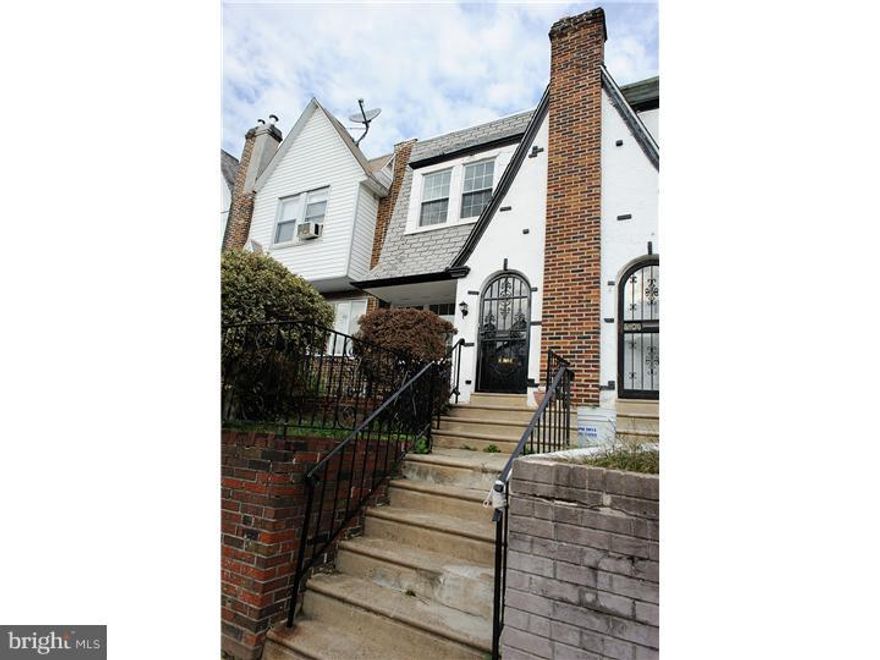 Quaint Tudor row home on quiet Mount Airy Street. This completely renovated home features hardwood floors throughout the first and second floors. Formal living and dining room spaces. Neutrally painted. Kitchen with maple cabinets and stainless steel appliances. Pottery Barn inspired full bath with subway tile, wainscoting and Carrera marble flooring. Spacious finished basement with half bath provides extra space for entertainment, play area or office space. Washer and Dryer included. Small elevated balcony off from kitchen. Private front patio. Home is located within minutes of Cheltenham and Cedarbrook malls. Close to transportation for easy commute to Center City. One year home warranty included in purchase. Submit your offer in time to spend the holidays in your new home!