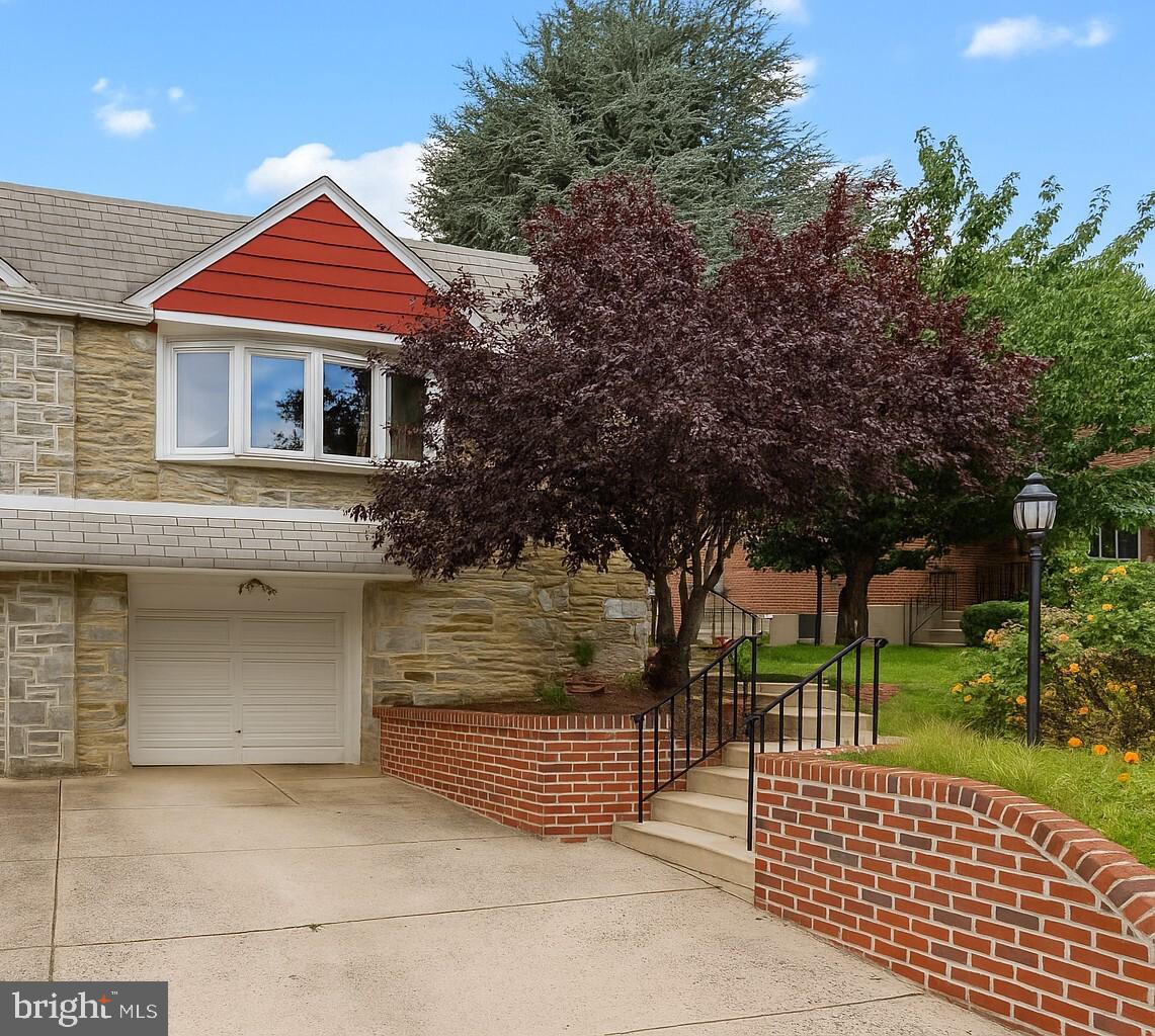 Welcome home to this charming 3- bedroom twin home with potential IN-LAW SUITE, located in the heart of the Bustleton community of Philadelphia. Boasting versatile living space and thoughtful upgrades throughout, this home offers the perfect blend of comfort and functionality. A private pathway leads you through beautifully manicured landscaping, welcoming you to your front door. Enter to your bright and spacious living room highlighted by a large bow window that floods the space with radiant sunshine. A few steps up, your dining room shines beneath an elegant chandelier and flows seamlessly into your modern kitchen featuring a stylish backsplash, upgraded quartz countertops, gas cooktop, stainless steel appliances, garbage disposal, Bosch dishwasher, and abundant cabinetry and counter space. Continue down the hall to 3 spacious bedrooms, each with plush carpeting and plenty of natural light. Your primary suite boasts a private ensuite full bathroom with stall shower. A full hallway bathroom with tub/shower combo and skylight for added brightness completes this floor. Step downstairs to your large family room featuring direct access to your covered outdoor patio – perfect for indoor/outdoor entertainment! Take a few steps further to discover your potential in-law suite boasting its own private entrance, a SECOND kitchen (complete with oven/range, sink, and refrigerator), laundry area featuring Energy Smart high-efficiency front load washer and gas dryer with storage drawers, AND versatile bonus rooms with closet that offer potential for a home office, 4th bedroom, hobby space, or craft room! Step outside to your private backyard oasis, where mature landscaping and privacy fencing create a serene retreat. Enjoy your covered patio, ideal for entertaining friends and family or unwinding with your morning coffee. A bonus shed provides plenty of extra storage for all your essentials. This home offers a 1-car garage and driveway for ample parking! Other recent upgrades include NEW block windows in the laundry area (2025), hardwood flooring under rugs on the main level, NEW brick pointing of the front concrete area, front steps, and patio paver stones (2025)! Ideally located close to a variety of restaurants and shopping yet near Philmont Train Station with direct service to Center City, Route 1, I-95 and the PA Turnpike for easy commuting! Don’t miss your opportunity to see this beautiful home today!