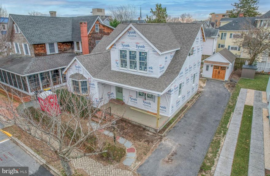 28 Virginia Avenue welcomes you home to the charm of Rehoboth Beach. This classic home is undergoing renovations down to the studs that will recreate a timeless coastal cottage, reminiscent of those originally built along the streets of our popular coastal town. Situated on a 50’ x 100’ ocean block parcel, this home is just feet from the boardwalk, beach, Lake Gerar park and playground, and all of downtown Rehoboth’s amenities. 28 Virginia Avenue’s gray cedar shake exterior, cozy screened porch, natural stone porch floors and fresh landscaping will create the most welcoming curb appeal. The original floor plan has been customized to reflect today’s open concept and featuring two floors with a total of 6 bedrooms and 5 full baths. In addition a detached accessory building has been converted to a carriage house that provides additional space to escape. The crisp new interior was created with the most discerning buyer in mind with tasteful appointments and selections throughout. Warm wide plank engineered hardwoods in the color “Dune” meander throughout living spaces, bedrooms, kitchen and hallways. The original wood burning fireplace and a reclaimed wood mantle that sets the tone for comfort and relaxation in the living area. This cozy living space is open to a gourmet kitchen that is host to Kraftmaid cabinetry in Dove White with Harbor Mist accents, Calacatta gold quartz counters, GE Café Series appliances in white with brass hardware, an expansive 10' island, and wet bar with dual beverage refrigerators. In addition, the first level interior is home to a dining area, spacious laundry room, a bedroom, full bath and an office that could easily be the 6th bedroom. The second level features 2 spacious primary suites complete with oversized closets, and spa-like baths. This level also offers 2 additional bedrooms each with en-suite baths. 28 Virginia Avenue’s outdoor living spaces are ideal for beach living with spacious porches on the front and rear of the home. The rear porch boasts a serene setting overlooking the rear yard and is ideal for outdoor dining and entertaining. And do not overlook the highly desired outside shower for a quick rinse after the beach. With a targeted completion of this spring, this home could be the perfect get-away for the summer of 2023.