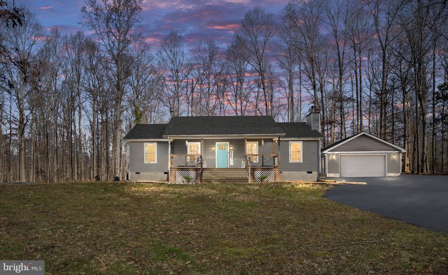 Beautifully updated home on a secluded 1.9-acre mostly wooded lot offering privacy, charm, and modern upgrades throughout. This inviting 3-bedroom, 2-full-bath home features hickory hardwood floors throughout and a cozy living room anchored by a soapstone wood stove, creating a warm and welcoming atmosphere.
The updated kitchen offers gas cooking, butcher block countertops, ample cabinetry, and a functional layout ideal for both everyday living and entertaining. A sunroom with tiled floors provides additional light-filled living space and gas fireplace while the full front porch and covered patio with pergola create perfect outdoor settings for relaxing or hosting guests.

The primary bedroom includes an attached, fully renovated full bath, offering a comfortable private retreat. Recent upgrades include new siding, a new roof, new HVAC, and a new water heater, providing peace of mind for years to come.

Outside, the property features a detached 24x26 oversized garage with its own 200-amp service, heat, and air, along with a wood shed and additional storage shed—ideal for a workshop, hobbies, or equipment storage. With no HOA, enjoy the freedom and tranquility of country living while still being convenient to modern amenities.

This exceptional property blends privacy, quality upgrades, and timeless appeal—truly a place to call home.