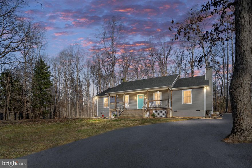 Beautifully updated home on a secluded 1.9-acre mostly wooded lot offering privacy, charm, and modern upgrades throughout. This inviting 3-bedroom, 2-full-bath home features hickory hardwood floors throughout and a cozy living room anchored by a soapstone wood stove, creating a warm and welcoming atmosphere.

The updated kitchen offers gas cooking, butcher block countertops, ample cabinetry, and a functional layout ideal for both everyday living and entertaining. A sunroom with tiled floors provides additional light-filled living space and gas fireplace while the full front porch and covered patio with pergola create perfect outdoor settings for relaxing or hosting guests.

The primary bedroom includes an attached, fully renovated full bath, offering a comfortable private retreat. Recent upgrades include new siding, a new roof, new HVAC, and a new water heater, providing peace of mind for years to come.

Outside, the property features a detached 24x26 oversized garage with its own 200-amp service, heat, and air, along with a wood shed and additional storage shed—ideal for a workshop, hobbies, or equipment storage. With no HOA, enjoy the freedom and tranquility of country living while still being convenient to modern amenities.

This exceptional property blends privacy, quality upgrades, and timeless appeal—truly a place to call home.