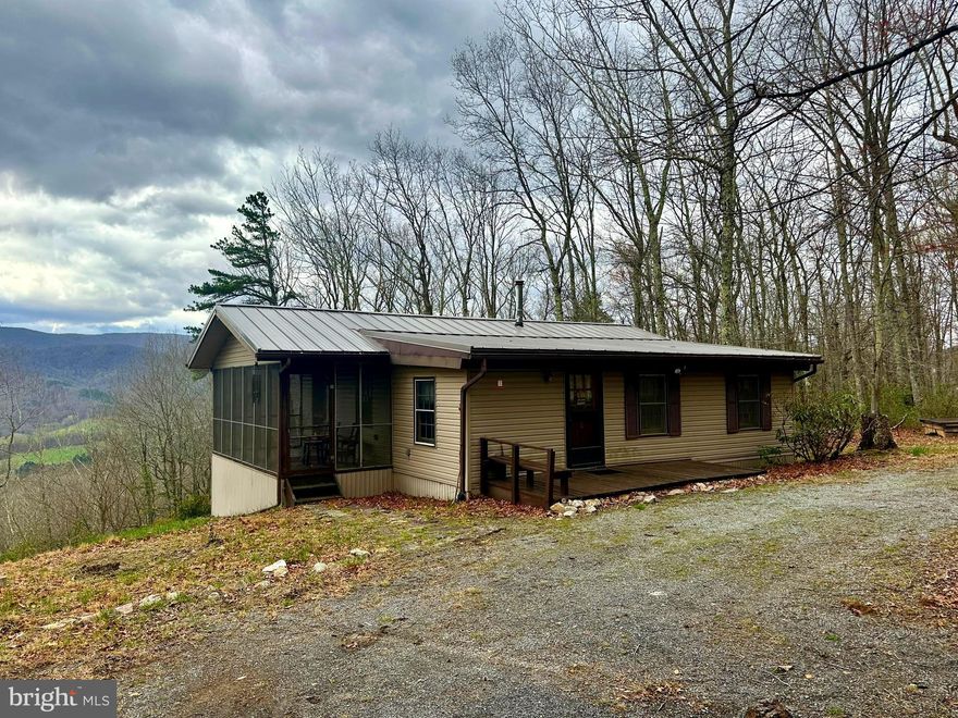 Absolutely AWESOME VIEWS from this 3 BR, 1 BA bungalow tucked away in Pendleton County. With 14+ acs, hiking & ATV trails, a firepit, large screened in porch, & spacious Garage/Barn, this property has much to offer. Most furniture & furnishings will convey. New Standing Seam METAL ROOF installed in 2021.  Enjoy the warmth of the wood stove during the cooler days or sit on the screened porch to be refreshed by the cool summer breezes.