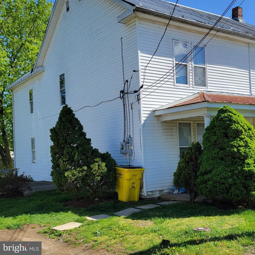 Investment opportunity. One half of an old farmhouse (1895 per tax record) divided into 2 units. Just over 700 sf on each level.  Sale includes just the 2 units on left half of the farmhouse.
2 bedrooms and a full bath in each unit. Small kitchen and dining table area. Lower unit has washer and dryer hookups. You can live in one unit and rent the other to pay your mortgage. Large storage shed in large rear yard. Possibly subdivide, build another rental unit or two.  Many possibilities for the savvy investor. Purchaser to perform due diligence with County in regards to further development of property.
Property is being sold as-is.