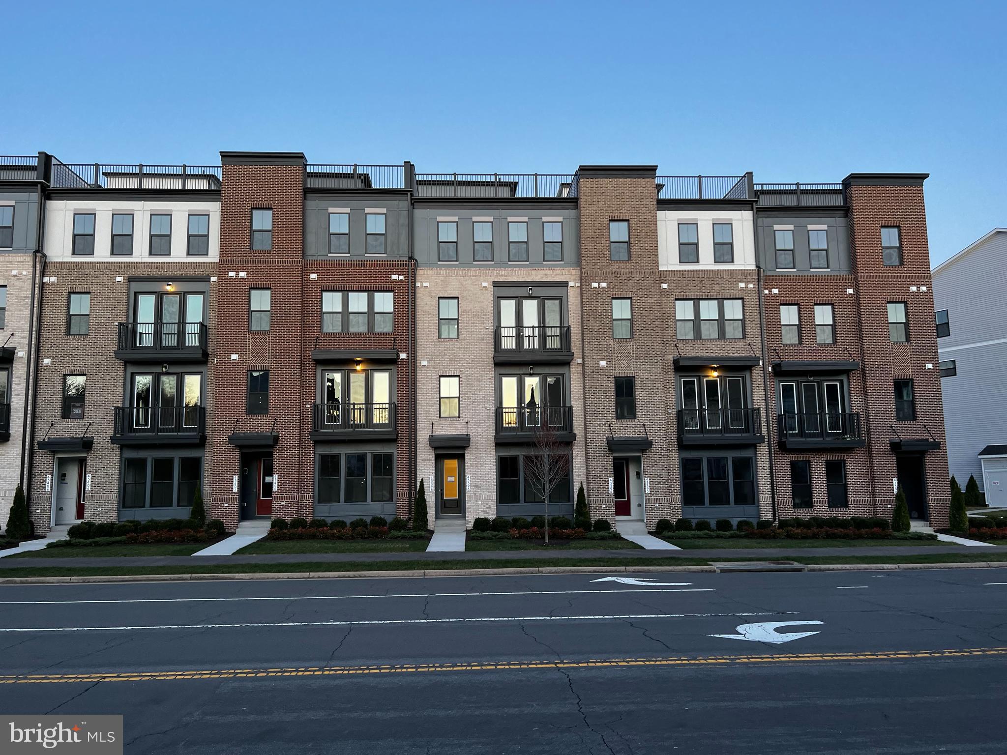 This light-filled Van Meter Collier II condo lives like a town home with four levels, three spacious bedrooms and two full and two half baths. A HUGE rooftop is the icing on the cake! Desired features include tall ceilings, large windows and luxury vinyl plank through much of the home.
Enter on level one through front door or garage into spacious rec room with half bath. The second floor features kitchen with stainless appliances (including double oven & French door refrigerator), quartz counters, island with seating and opens to living area with French door to balcony. There’s also a powder room on this level. The third level is devoted to primary bedroom with private balcony, two walk-in closets and luxury bathroom with double sinks and oversized frameless shower. Level four features two spacious bedrooms and a full bath. Remember that rooftop deck? Your guests won’t forget this amazing entertainment space with view for miles including mountains to the west.
No worries on where to park. One car garage offers electric car charging capabilities and there’s also a driveway space and ample parking.Farringdon Square is situated in the amenity-filled community of Broadlands with pools, parks, green spaces, hiking biking and walking trails, shops, restaurants and more. COMMUTING OPTIONS: Walk to bus stop and Metro Silver Line station, Greenway is less than a mile and Route 28 a short drive. OWNER WILL CONSIDER ONE DOG LESS THAN 20 POUNDS.