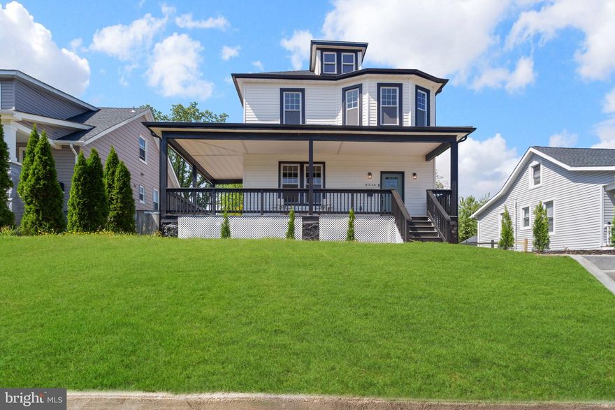 Welcome to this Stunning, fully renovated 4-bedroom, 4.5-bath porch-front home in the Historic Lauraville Baltimore neighborhood! This move-in-ready residence features a bright, open-concept floor plan with an electric fireplace and abundant natural light. The designer chef’s kitchen boasts quartz countertops, soft-close shaker cabinets, stainless steel appliances, an Island, and a stylish backsplash, perfect for cooking and entertaining. The main level also features an in law-suite, perfect for guests or in-laws. The second level  primary suite is a private retreat with an ensuite bathroom including a double-sink vanity and a tiled walk-in shower for a spa-like experience. The fully finished basement provides a family room and full bathroom for additional living space. All-new systems and updates: architectural shingles roof, vinyl siding, windows, doors, flooring, HVAC, water heater, plumbing, and a fully rewired 200-amp electrical system. Modern touches such as recessed LED lighting and smart Nest thermostat offer comfort and energy efficiency throughout. Step outside to enjoy the large fenced backyard with new deck, perfect for summer gatherings, while the front porch provides a relaxing outdoor retreat, the driveway adds city-living convenience. Located near Morgan state university, downtown, major highways, shopping, and entertainment, this home blends style, functionality, and lifestyle. All permits pulled — schedule your showing today and don’t miss this incredible opportunity!