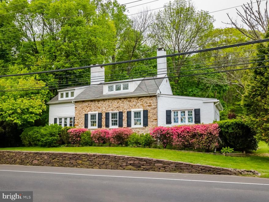Founded on over two acres this 1840's restored, and renovated farmhouse has maintained all the charm of an era gone by while incorporating the modern amenities of today. A detached workspace  offers its own deck with pergola. The main house includes three bedrooms, two full baths and a large patio that enjoys a lush view. The tiled sunroom affords the original stone wall and an energy efficient wood-burning stove as the vaulted ceiling with skylight and exposed beams creates a very inviting appeal for family and friends. Deep-silled windows bring in the colorful landscaped views and a Dutch door gives you direct access to the kitchen. With the rich hardwood floors, built-in shelving units, numerous windows and the walk-in fireplace with mantle the formal living room is an ideal conversational area. Notice the original doors with latches, one is a pie-stairwell leading upstairs, the other takes you to the dining room. With the character of the exposed beams, the hardwood floor and faux fireplace, guests will feel enchanted when dining in this charmed room. A large eat-in kitchen is the heart of the home regardless of which century you live in. This bright and airy kitchen is no different. A custom barstool table provides casual seating, stone counters that stretch up the backsplash to the cherry cabinets and a seamless sink donning dark bronze fixtures including sprayer and soap dispenser. The first-floor master suite is flush with built-in cabinetry, enjoys the extra spaciousness of a raised ceiling, brings in the pretty green views and has a private bath with step-in shower. The unique stairwell gives the two bedrooms upstairs a sense of privacy with their own hallway. Each room has its own character with the architectural lines meeting the banks of windows that bring in a sunny ambiance. There is also ample closet space and a shared full bath. An amazing space, the original outbuilding with wood burning stove gives you the opportunity to have an inspiring art studio, home office or a workshop that could be the ultimate man cave, let your imagination soar. A brand-new septic system was installed in May of 2019, there's extensive parking, you are in the nationally ranked Central Bucks School District plus are central to Newtown, Doylestown and New Hope. Don't miss out on this charming home!