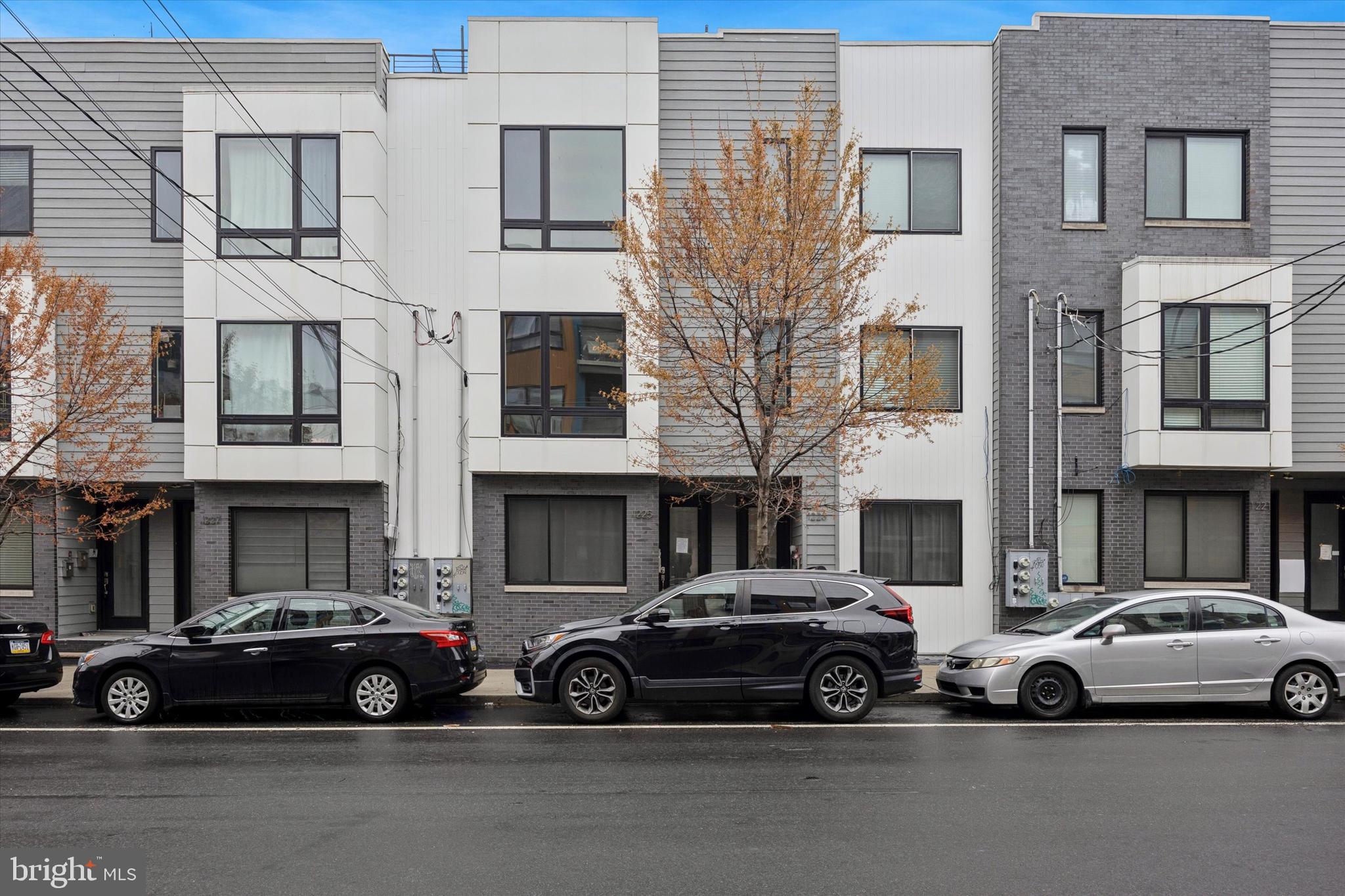 This is a gorgeous 3bd, 3ba bi level townhome with ROOF DECK , PARKING , over 2 years of tax abatement, and a Condo Association covers water! It sits at a PRIME location off Girard Ave, just two blocks away from the center of Fishtown and Northern Liberty. With a extra wide frontage of 17ft and 48ft in depth, this spacious 2017 home features a desirable open floor plan, with hardwood floors throughout, large windows and tons of natural light year round! There is a nice sized bedroom and a full bath on the main level with spacious storage and closet. The second floor of the condo features 2 spacious bedrooms with large closet spaces, one has its own full bath with a glass shower and double sink. There is another full bathroom in the hallway and a full size laundry. Upstairs is the stunning roof deck with great views to the city! Never worry about finding street parking, park in your own space directly behind your building and walk into your back door! If you are a dog owner there is a conveniently located dog park in the rear of the building too! The residents love to gather here and catch up:). Current walk score of 95 great walkability to all the retail, restaurants, and nightlife Northern Liberties and Fishtown has to offer. Just a few min away to reach route 95! This is a home that offers excellent location, modern comfort, high functionality, space, convenience and affordability at the same time.