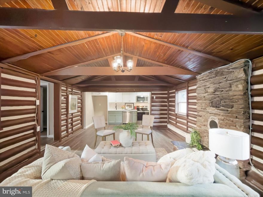 Welcome to 142 Hilltop Road, a fully renovated home transformed into a peaceful private retreat overlooking Fishing Creek. Situated on nearly one acre, this property offers exceptional privacy, scenic views, and thoughtful updates throughout. The main level features an open living room with exposed wood beams and vaulted ceilings, creating a bright and inviting atmosphere. A flue with a stone surround is ready for a wood or pellet stove, adding both character and functionality. The brand-new custom kitchen is equipped with quartz countertops, stainless steel appliances, and modern finishes. An additional sunroom provides flexible space ideal for a sitting room, home office, or playroom. The main level also includes a fully renovated bathroom with a walk-in shower and a spacious bedroom with large windows that offer abundant natural light and views of the stone patio and firepit area. The upper level provides versatile flex space that can be used as a second bedroom or an additional living area. Outdoor living is enhanced by a large wraparound deck, perfect for relaxing or entertaining while enjoying the surrounding views and natural setting. 100% no-money-down financing is available for qualified buyers, along with flexible seller financing options, making this a unique opportunity to own a beautifully updated home in a serene location. Call today to see this beauty in person!