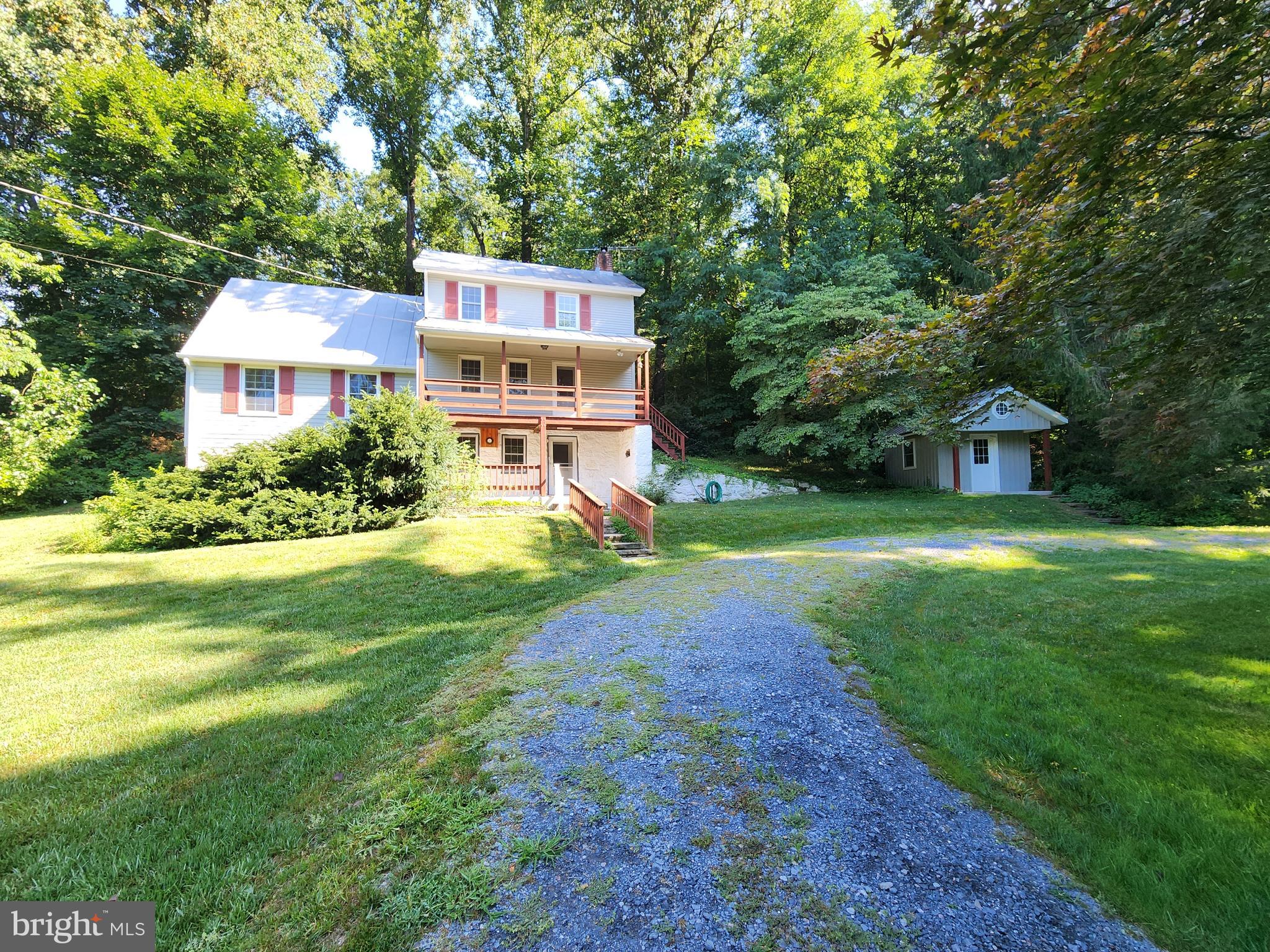ONLINE AUCTION: Bidding begins 8/14/2025 @ 10:00 AM. Bidding ends 8/18/2025 @ 11:00 AM. List Price is Suggested Opening Bid. Deposit: $25,000. Discover the charm of rural Maryland with this historic 1865 stone farmhouse, updated with a modern 1984 addition. Tucked away on 6.44 wooded acres with a freshwater stream, circular driveway, and multiple outbuildings, this unique property blends rustic character with contemporary upgrades.
Interior features include a spiral staircase, cathedral ceilings, visible log walls, knotty pine paneling, and a country kitchen with upgraded ceramic countertops. Recent improvements include double-pane windows, a whole-house propane generator (500-gallon underground tank), and a dehumidifier with automatic pump. Property is serviced by satellite internet and TV with quantum fiber internet connection up to the home.
Enjoy the tranquility of covered porches, stone retaining walls, and scenic views of the surrounding trees and creek. Located just minutes from Westminster with easy access to MD-140 and MD-97.
Septic system was professionally pumped and serviced on 11/15/2023 by Fogle’s Septic Clean, Inc. Invoice available in the Documents tab.
This sale includes 2 Carroll County Tax ID's: (0706044972 & 0706055281).