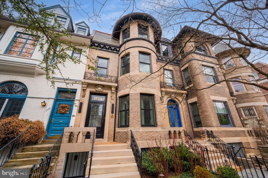 A seamless fusion of historic Washingtonian elegance and contemporary luxury, 1725 19th Street NW is a classically refined Dupont Circle townhome, meticulously reimagined by the visionary minds at Fowlkes Studio Architects and JD Ireland Interior Design.  Prominently positioned on a tranquil, tree-lined street, its timeless curb appeal is accentuated by intricate original detailing, modern windows and fixtures, and a slate roof.
 
At the top of the entry steps, an elegant vestibule with bespoke Ferris Custom built-ins offers a graceful transition from outdoors to in. The reception area, featuring a sophisticated powder room, introduces an expansive 4,500-square-foot layout. Adjacent, the formal living room is anchored by a roaring fireplace flanked by integrated bookshelves, while a grand curved bay window frames the gated front lawn.
 
Beyond the central grand stair hall, with its custom runner and sculptural sconces, lies the dining room, featuring another stately fireplace. Designed to balance formality and effortless flow, the space opens seamlessly to the showstopping chef’s kitchen. Sleek, minimalistic Ferris Custom cabinetry is juxtaposed with dramatic, unbroken slabs of white marble draping the backsplash and waterfall island. A SubZero, Wolf, and Thermador appliance suite ensures peak culinary performance. The adjacent breakfast room, framed by a striking three-story metal and glass partition by Weldwork, offers direct access to the rear deck. A double-height wall of windows floods the space with natural light, accentuating the unique spiral staircase.

On the first upper level, a generous front bedroom suite enjoys an ensuite bath and a curved bay window overlooking the streetscape. The secondary bedrooms showcase Duravit vanities and Signature Hardware finishes, with one bedroom opening dramatically to the breakfast room below via a wall of glass. A hall bath and convenient laundry room complete the level.

Commanding the entire top floor, the primary suite is a private oasis. A statement-making Farrow & Ball wallpapersets the tone in the sleeping area, where a large bay window offers sweeping views. A galley-style dressing room, lined with custom built-ins, leads into the showstopping primary bath, featuring a Ferris Custom double vanity, oversized walk-in glass shower clad in imported Nerosicilia Mosaicomicro tile, and WaterWorks fixtures throughout. At the rear, a private lounge with panoramic windows is accompanied by a custom wet bar, finished with Emperador Dark stone and Signature Hardware fixtures, while an adjacent home office completes the suite.

The fully self-sufficient lower level features a private entrance, a spacious living and dining area, a full kitchenette, two additional bedrooms, a full bath, a powder room, and an additional laundry room—enhancing both functionality and versatility. Additionally, this lower level can be reconnected to the main house to allow for additional  living space, if desired. 

Outside, the rear deck steps down to a private terrace, leading to a dedicated two-car parking pad. In striking contrast to its historic façade, the rear elevation embraces a bold contemporary aesthetic, showcasing the Weldwork glass partition.

Nestled just two blocks from Connecticut Avenue and a five-minute walk to Dupont Circle Metro, 1725 19th Street NW offers unparalleled access to the city’s most coveted shopping, dining, and nightlife. A masterclass in architectural synergy, this residence is poised to redefine luxury townhome living in Washington, D.C.