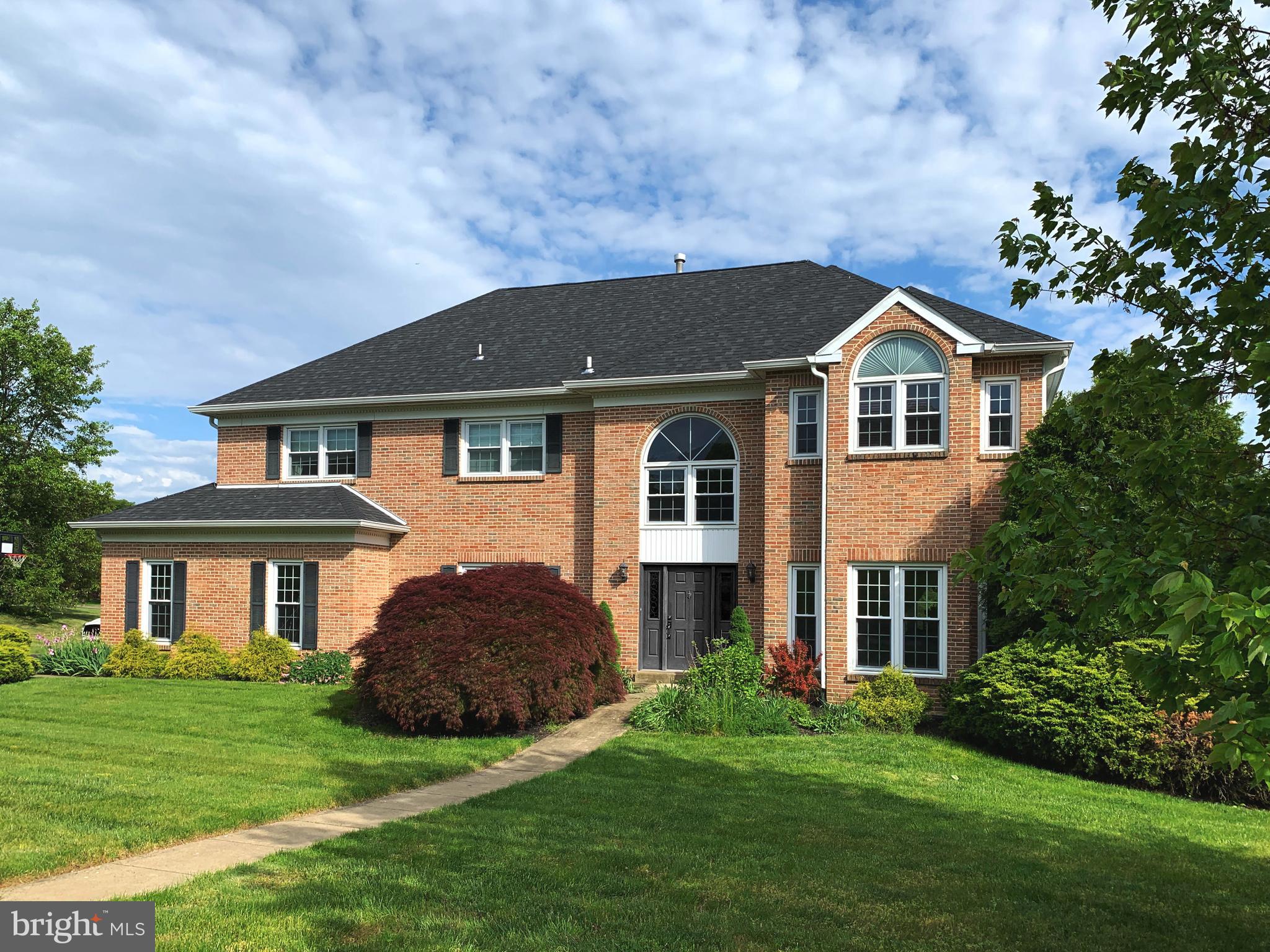 Welcome to Your Dream Home in Dublyn Lea!
Discover the pride of ownership in this stunning brick-front Colonial, boasting 4,550 sq. ft. (including a finished basement) of luxurious living space. Nestled in the mature Upper Dublin neighborhood of Dublyn Lea, this home offers 4 bedrooms, 2 full baths, 2 half baths, and a true walk-out basement. Set on a beautifully landscaped ¾+ acre level lot, the backyard is perfect for volleyball, touch football, or a game of catch with the little ones. Step into the grand 2-story foyer adorned with a starburst chandelier and hickory hardwood floors that flow seamlessly throughout the main level. The 9-foot ceilings add a touch of grandeur to the home. To the left of the foyer, you'll find an office with built-in desk, bookshelves, and a reach-in closet, which can double as a 5th bedroom. To the right, the stacked living and dining rooms. The large Box window in the Living Room and recessed lights, creates a bright and cheerful space perfect for a playroom. The island kitchen is a chef's delight, with 42” shaker-style wood cabinetry, soft-close doors, pantry, built-in oversized refrigerator, stainless steel appliances, granite countertops, matte subway tile backsplash, and recessed lights. Sliding doors off the eat-in kitchen lead to an oversized redwood-stained deck overlooking the expansive and private backyard. The oversized family room is highlighted by a floor-to-ceiling stone wall fireplace, perfect for cozy evenings. The main level also includes a remodeled laundry room with cabinetry and a new sink, and a separate remodeled powder room. New carpeting flows seamlessly throughout the second floor. The upgraded wrought iron stair balusters lead to the upper level, where the primary bedroom offers 2 walk-in closets with professional organizers. The large sitting room with a multi-angled vaulted ceiling can easily double as a second office, private reading space, or nursery. The remodeled primary bath features vaulted ceilings with a skylight, double vanity with granite tops, heated tile flooring, and frameless clear glass shower doors with 3 shower heads. The remaining 3 bedrooms are oversized, each with lighted ceiling fans. The guest bathroom has been completely remodeled with luxury vinyl plank flooring, quartz countertops, all new fixtures, designer mirrors, and multi-tonal LED lighting. The finished, 9-foot high, walk-out basement offers two separate areas. Walk through the double French doors past the custom wet bar with recessed shelving and accent lighting into the media room, complete with theater seating for 6, a 120-inch screen, and surround sound speakers. The walk-out side of the basement is currently set up as an exercise room, with the convenience of a powder room ideal for family gatherings or sleepovers. Located in the award-winning Upper Dublin School System and minutes away from beautiful Mondauk Park, the new Promenade outdoor shopping mall, George's Market and near all major roads and Septa train staion. This home has been meticulously upgraded with a new 50-year architectural shingle roof, replacement windows and sliders, remodeled kitchen, replacement front door, remodeled bathrooms, new light fixtures, replaced electrical outlets, many replaced sidewalk squares and driveway apron, and freshly painted interiors. Imagine creating lasting memories in your new home. Don't miss this wonderful opportunity!