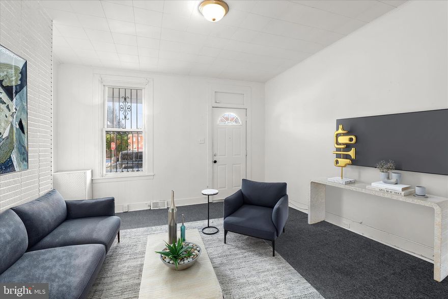 Welcome to this 3 bedroom, 1 bath semi-detached rowhome that offers solid potential for renovation and personalization. The main level features an open floor plan that begins in the living room, continues through the dining area, and flows into the kitchen. A walkout from the kitchen leads directly to the fully fenced rear yard with a parking pad, providing convenience and outdoor space.

Upstairs, the three bedrooms and full bath provide a functional layout ready for updates. With close access to I-95, I-695 and I-83, this home offers straightforward connectivity for commuting or investment purposes. Whether you are looking to create your own home or expand your rental portfolio, the fundamentals are in place for your next project.

Note:  Select interior photos have been virtually staged.