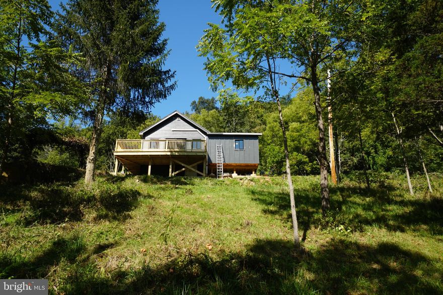 Exceptional Riverfront investment opportunity with this stunning new construction cabin-style home built in 2024. Nestled on a  7.94-acre lot, this easily accessible property along US Rt 220 South, offers a unique blend of recreation and earning potential, with 2 bedrooms and 1 full bath designed for modern living. Step inside to find an open floor plan that seamlessly connects the living, dining, and kitchen areas, enhanced by track lighting and ceiling fans for comfort. The luxury vinyl plank flooring adds a touch of elegance, while the combination kitchen/dining space is perfect for entertaining. The home comes furnished and includes essential appliances such as an electric oven/range, refrigerator, and stacked washer/dryer, making it move-in ready for future tenants or vacationers. With approx. 2640 feet of riverfront along the South Branch Potomac, enjoy exclusive access on your own property for canoeing, kayaking, fishing, and swimming-ideal for attracting outdoor enthusiasts. This property is not in a development and offers year-round access. The walking paths along the property into the partly wooded landscape leads to recreational area complete with brick pizza oven along the riverfront. With this unrestricted property , the potential for rental income or personal use is limitless. Imagine the returns from short-term rentals or a wonderful retreat for nature lovers. If you feel the need to venture out, you can drive 30 minutes West of Franklin to Seneca Rocks Recreation area and then on to Blackwater Falls & Canaan Valley. To the East, it's located 1 hour from Harrisonburg, VA. Seize this chance to invest in a property that promises both immediate enjoyment and long-term value. Don't miss out on this rare gem!