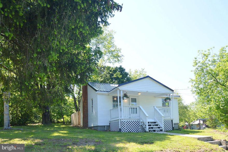 Close to town!!  Move-in ready!! - This charming bungalow/cottage is ready and waiting for its new owner!  Originally built in 1920, this home has had some recent updates: (including, but not limited to) new metal roof, refinished wood flooring, new refrigerator and range, as well as brand new hot water heater.  The main level of this home features the potential for 2 bedrooms, or 1 bedroom with office as well as 1 bathroom with walk-in shower.  Open floorplan in the living/dining area, just a step away from the kitchen.  Head outside from the kitchen to your own private, fenced-in oasis.  The lower level/basement provides a washer/dryer hookup as well as the potential for a woodstove for those chilly winter months.  Basement also has exterior access through the Bilco door.  Enjoy the summer nights on the front porch, or sitting by your firepit on the leveled pad site.  Home is situated on a .2773 acre lot, less than a mile from downtown Berkeley Springs, Town of Bath with all of the local shops and spas.