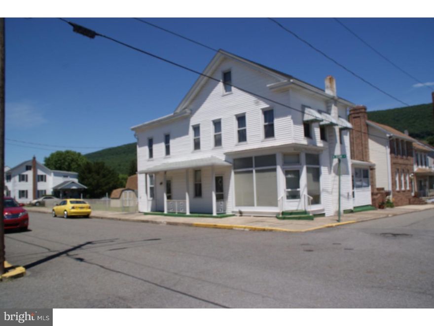 Large home with store front and or office.   Corner lot with fenced yard. Sun porch.