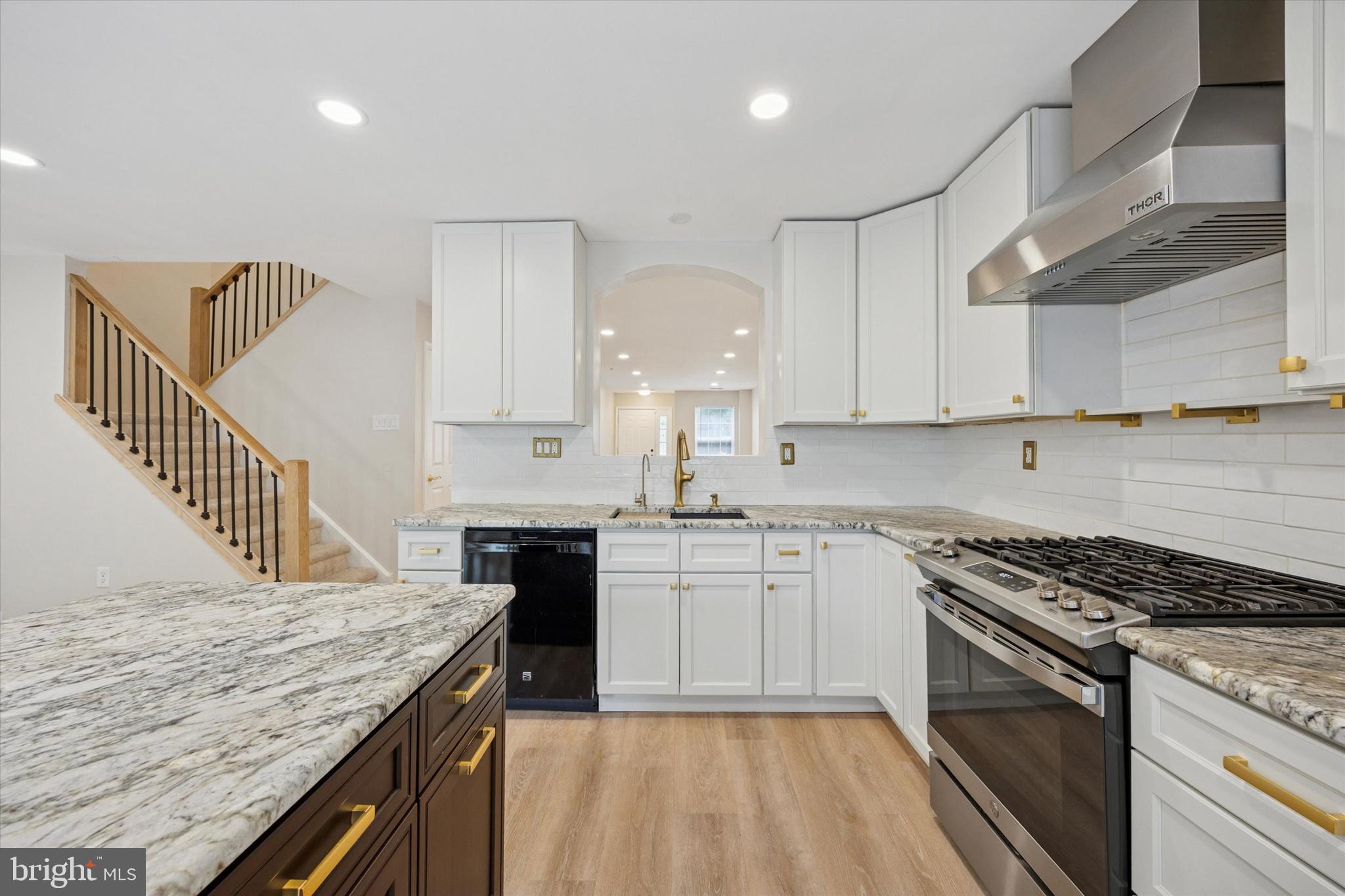 Step into modern comfort in this beautifully updated home featuring thoughtful design and quality finishes throughout. The first floor offers neutral flooring and soft neutral wall tones that create a warm and inviting atmosphere. A spacious one car garage and convenient powder room add functionality, while the heart of the home is the bright and stylish kitchen. It features white shaker cabinetry, granite countertops, gold fixtures, a gas range with vented exhaust, dishwasher, 42 inch tall cabinets, and a charming farm style sink. The island provides seating for two, and a back door off the kitchen leads to an incredible deck with access to the backyard, perfect for entertaining or relaxing. The walkout basement includes brand new sliding glass doors that open to the backyard, along with generous storage options and a closet space equipped with ample shelving. Upstairs, the second floor includes a dedicated laundry room with washer and dryer, three bedrooms, and two full bathrooms. The primary bedroom offers a spacious retreat with a soaker tub, a newly renovated shower stall, and a custom walk in closet. There is also a space for your in home office. Additional features include a linen closet and abundant closet space throughout the upper level. This home combines modern style with everyday comfort in every room and is ready for you to move in and enjoy.