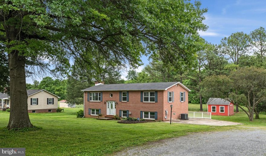 This charming all brick 4-bedroom, 2-bath brick split foyer home in the Shasta East subdivision features a traditional floor plan. On the main level, you will find 3 bedrooms, 1 full bath, a living room, a dining room, and a well-appointed kitchen. The lower walk-out level offers additional living space, including a spacious family room with a gas fireplace, a laundry area, a kitchenette, a bedroom, and a full bath. Outside, there is a large yard (.49 acres)with mature trees, a shed, and a large deck equipped with a wheelchair lift. This home combines comfort, functionality, and convenience in a peaceful community setting. Don't miss the opportunity to make this your new home! Located minutes from Charles Town WV - close to shopping. All sizes are approximate.