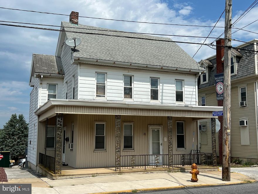 Thinking of becoming an Investor?  Want to add to your already established Investor Portfolio?  Maybe you are looking for somewhere to live and would like a tenant to help with your mortgage costs.  Whatever the reason this listing caught your eye, this 2-Unit located, in Dallastown Borough, is worth a look.  Both units are currently occupied.  The 1st floor unit features a living room, eat-in kitchen, two bedrooms, a full bath, a bonus room, laundry/basement access, and a small deck off the kitchen.  It has front porch, side porch, and rear deck access. It rents for $700/mth. and is very clean.  Tenant rented directly through Owner. The 2nd floor unit features an eat-in kitchen, living room, two bedrooms, a full bath, and walk-up attic access.  It also has a small deck off the kitchen.  It does not have laundry hookups.  A small patio is at the bottom of the steps.  It also rents for $700/mth.  Tenant rents through Southern Prop Mgmt. Property Owner pays water, sewer/trash, and gas (shared water heater).  Units have electric baseboard heat which they pay.  The property sits on the corner of Main St and Kauffman Ave.  It has a wrap-around porch and both units have access to two parking spaces each.  The additional parking, at the bottom of the lot, are used and maintained by the Dallastown Legion, via an Easement Agreement.  AGENTS - VERY IMPORTANT to read Agent Remarks!