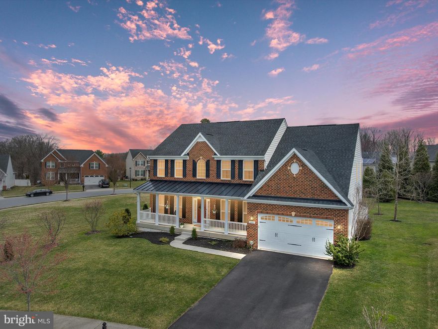 This stunning brick-front Colonial is nestled in the prestigious Windlass Overlook community, perfectly positioned on a corner lot adjacent to a spacious common area. The home presents an aesthetically pleasing curb appeal with an inviting front porch. Boasting over 5,000 square feet of thoughtfully designed living space. Upon entering, an open foyer with gleaming hardwood floors sets the stage, flanked by a formal living room  with crown molding and a private home office, ideal for today’s remote work lifestyle. The open-concept kitchen features stainless steel appliances, granite countertops and a large center island perfect for entertaining, while overlooking both the family room with a gas fireplace and the morning room, which provides effortless access to the Trex deck, ideal for hosting outdoor gatherings. A spacious formal dining room completes the main level. Upstairs, the home offers four generously sized bedrooms, three full bathrooms, including a luxurious primary suite with a spa-like en-suite bathroom, two walk-in closets, and a bonus sitting area. The conveniently located upper-level laundry room adds to the home's practicality. The fully finished basement has it all, boasting a spacious recreation room, full bar, large storage area, and rough-in plumbing for a future bathroom. Additional notable upgrades include an outdoor sprinkler system, new washer, new microwave, and new refrigerator. Ideally situated near shopping, dining, and major commuter routes (I-95/I-695), this exquisite home offers the perfect blend of luxury, comfort, and convenience.