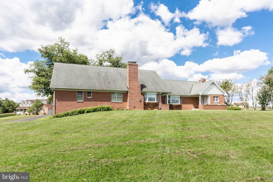 This custom brick Cape Cod in Carroll County offers an impressive blend of space, versatility, and value, featuring five bedrooms, five full baths, and two half baths. Beautiful hardwood floors run throughout, enhancing the home’s expansive and well-designed layout. Meticulously maintained and exceptionally clean, this is a rare opportunity at a compelling price.

The kitchen and bathrooms showcase custom cabinetry, providing both style and abundant storage. A formal dining room—currently used as a billiard room—offers flexible living options, while the oversized family room easily accommodates a music area and still leaves plenty of space for relaxing and entertaining. The main level includes three bedrooms and three-and-a-half baths, creating convenient one-level living.

Upstairs, you’ll find two spacious bedrooms, each with its own private full bath. Designed with efficiency in mind, the home features multiple zoned heating systems for personalized comfort throughout. The lower level presents endless potential—ideal for additional living space, a workshop, wine storage, or general storage—and already includes a half bath.

Outside, a fenced area—formerly home to a pool—offers a great space for pets or future outdoor enhancements. Set on a deep 2.5-acre lot with a three-car garage, the property provides privacy, space, and opportunity.

Whether you enjoy entertaining, pursuing hobbies, or simply embracing a more spacious lifestyle, this home offers the perfect setting to live, work, and unwind.