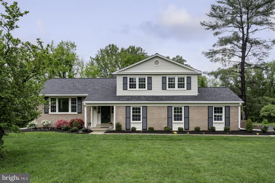 This is truly one of the most meticulously maintained homes I’ve had the pleasure of listing—every detail has been thoughtfully attended to. A brand new roof tops the home, and even the garage has been freshly painted, showcasing the care poured into every corner.

Inside, gleaming hardwood floors flow through the main-level living spaces, hallways, and staircase, adding warmth and elegance. The formal dining room exudes timeless sophistication with classic chair rails and wainscoting, creating the perfect setting for both intimate dinners and special occasions. The adjacent living room is equally stunning, featuring a large picture window flanked by two double-hung, floor-to-ceiling windows, flooding the space with natural light and framing picturesque views.

All five generously sized bedrooms feature new carpeting and lighted closets, while each bathroom has been beautifully renovated with modern finishes.

The heart of the home is the expansive, fully remodeled kitchen, offering abundant space for cooking, gathering, and entertaining as well as high end stainless appliances. Just off the kitchen, the massive family room is sure to become your favorite hangout, featuring a striking brick fireplace, built-in bookcase, authentic vertical wood shiplap, exposed beams, and classic wood parquet flooring—a charming blend of rustic and refined.

The main level also includes a third full bathroom and a laundry room with convenient access to the back deck. Step outside and relax under the large awning, surrounded by built-in bench seating, with access from both the laundry room and family room.

Downstairs, an unfinished walk-out basement with windows offers tremendous potential for additional living space. It opens to a lush backyard that backs to protected parkland and the W&OD Trail, offering privacy and natural beauty right outside your door.

Perfectly situated for convenience and tranquility, this home is nestled deep in the suburbs, yet remarkably close to everything. Dulles Airport is under 10 miles away, with easy access to the Toll Road, Route 66, Reston Town Center, and the Town of Vienna, all providing a variety of shopping, dining, and entertainment options. No HOA adds to the flexibility and value.

A comprehensive list of upgrades is available in the documents section—be sure to take a look!