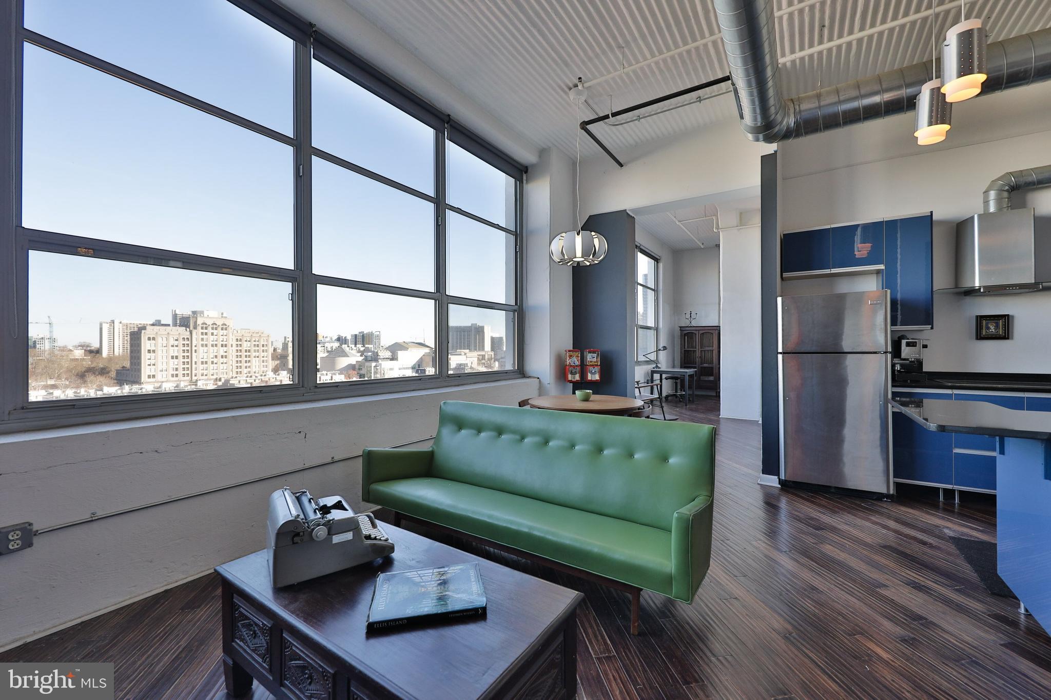FRESH NEW PRICE for this Bright & Airy 1+ bed, 1.5 bath CORNER UNIT Condo with loft, located on the 8th floor in the sought after 2200 Arch building, situated in the very desirable Logan Square. A COVERED DEEDED GARAGE PARKING SPOT IS INCLUDED IN THIS SALE! Enter the unit into a private foyer/hallway, which leads to the sun soaked living space, featuring over-sized wall to wall windows, hardwood flooring and a vaulted ceiling. This incredible unit has been decorated through an artist's eye with unique touches throughout the home. The lofted area is accessible through the living room, providing additional space for entertaining, guest quarters or storage. The living area flows into the dining space - ideal for entertaining with sweeping city views. Continue to the sleek & modern kitchen with ample cabinetry for storage. A small alcove directly off the kitchen would make a great computer nook or provide an abundance of additional storage. The bedroom features a seating area from which to soak up the beautiful city skyline, as well as a luxe 4 piece bath with soaking tub and glass stall shower. This ultra hip corner unit is one of the largest 1+ bedroom in the building and also features an additional hall bathroom, complete w/ cut out and water pipes for shower, making for a quick, easy and inexpensive conversion to a full bathroom. There is also a separate laundry area w/ included washer and dryer and additional shelving/storage. Wake up every day to incredible skyline views and no shortage for storage with two large closets in master. Building amenities include a 24-hour lobby attendant, well equipped fitness center, conference room area and Arch Gourmet grocery located on the 1st floor, accessible through the building. Located just steps from all that Center City has to offer, including Trader Joe's, The Schuylkill boardwalk, Museums and more.