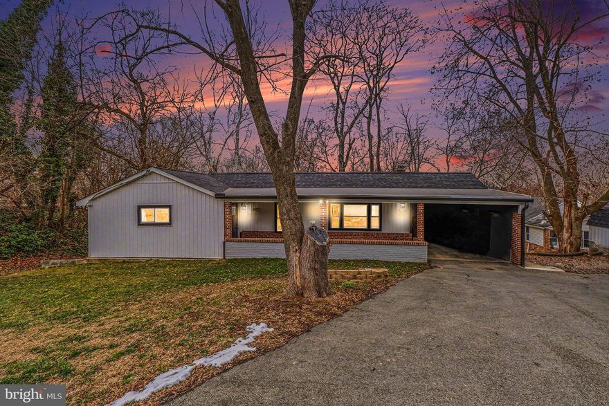 This charming ranch-style home, built in 1948 underwent some major renovations in 2025, offering a perfect blend of classic appeal and modern comfort. Nestled in a serene suburban setting, this property boasts approximately 1,300 sq. ft. of thoughtfully designed living space, featuring three spacious bedrooms and two full bathrooms. Step inside to discover a warm and inviting interior, highlighted by cove moldings and recessed lighting that create an ambiance of elegance. The combination kitchen and dining area is perfect for gatherings, showcasing upgraded countertops and cabinets, making meal preparation a delight. Relax in the luxurious soaking tub or enjoy the convenience of a shower in the beautifully appointed bathrooms. The exterior features include inviting porch spaces and well-placed exterior lighting, enhancing the home's curb appeal. The expansive 0.28-acre lot is surrounded by lush trees and woods, providing a tranquil view and a sense of privacy. An attached carport and asphalt driveway offer ample parking for you and your guests. With a full, daylight basement, there's plenty of room for storage or potential expansion. Enjoy the peace of mind that comes with insulated double hung and slider windows.  This home is not just a place to live; it's a sanctuary where comfort meets convenience, ready to welcome you home.