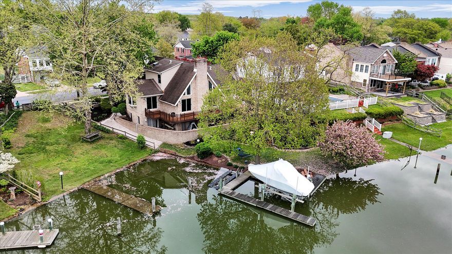 Nestled in the serene enclave of Rumsey Island, this exquisite contemporary home offers a luxurious lifestyle defined by elegance and comfort. Built in 1999 and thoughtfully renovated, relish in over 3400 square feet of above grade finished space that boasts a perfect blend of modern amenities and timeless charm, making it an ideal retreat for those seeking tranquility and sophistication.  •  As you step inside, you are greeted by an inviting floor plan that seamlessly connects the living spaces. The instantly capturing living room, adorned with a perfect waterfront view, vaulted ceiling, industrial fan and a cozy pellet stove is open to the gourmet, custom designed kitchen, featuring soapstone countertops, hand-made tile from Morocco, chef-grade appliances and countless custom finishes and conveniences.  •  The dining area, perfect for entertaining, is bathed in natural light, creating a quaint and welcoming atmosphere. Enjoy the convenient main level office space with an inspiring view and near silent laundry area with adjacent half bath.  •  This waterfront home affords 4 bedrooms. On the main level, a luxurious primary suite complete with custom upgrades throughout and the supreme essence of a spa bathroom.  •  Upstairs affords its own air conditioning system to maintain perfect comfort in the 2 additional bedrooms, full bathroom and access to garage attic space.  •  On the lower level, you will find a spacious 4th bedroom and full bathroom in addition to the spacious comfort of the family room with a cozy woodburning fireplace and direct walk-out to the serene waterfront.  •  The home also features an attached, weather-sealed 1-car garage with custom built-in storage, a newly added attic, custom electric and a negotiable EV Lev2 charger.  Outside, note the additional parking pad, new retaining wall and 2nd negotiable EV Lev2 charger.  •  Relish in the meticulously landscaped exterior, where extensive hardscaping complements the lush greenery of the front and rear yards. The private multi-level deck invites you to unwind and soak in the stunning water views of Sandpiper Cove. With 134 feet of waterfrontage, this property offers direct access to a variety of water activities, including the extensive pier, 10,000lb boat lift and jet sk/kayak dock.  The atmosphere is a true paradise for water enthusiasts.  •  Whether you're hosting gatherings or enjoying quiet evenings by the water, this home is a sanctuary that embodies the essence of luxury. Experience the perfect blend of comfort, style, and outdoor living in this remarkable Rumsey Island residence.  •  PLEASE Be sure to check out the extensive list of Fun facts, Updates & Improvements under Documents for loads of information.  • SECURE YOUR SHOWING TODAY FOR 4/30!