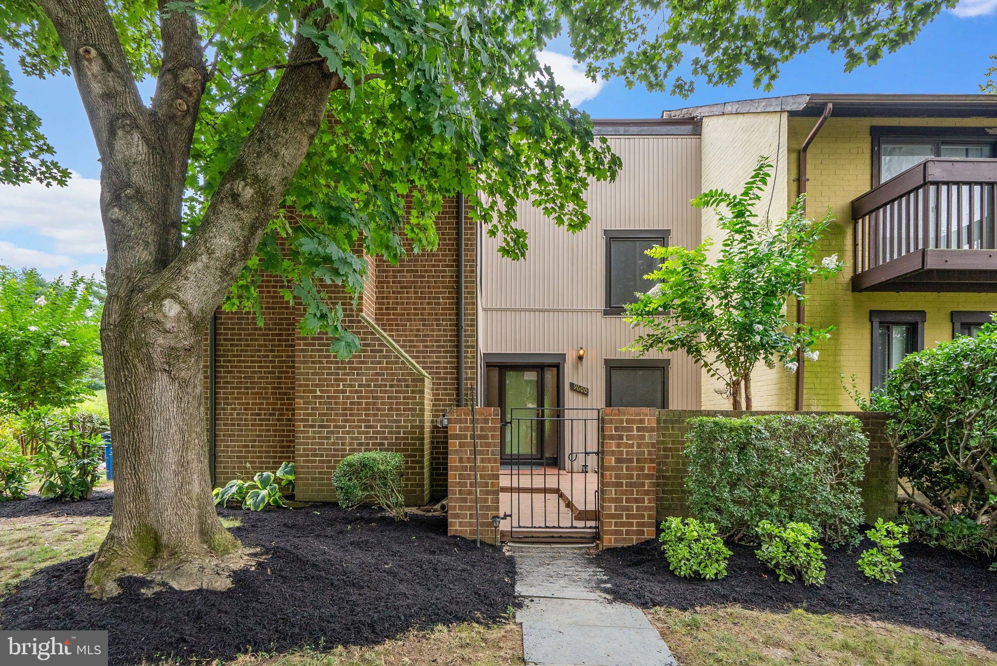 Step into this light‑filled end‑unit townhome with three outdoor spaces and room for everyone to spread out 2,476 finished sq ft. The main level welcomes you with hardwood floors and a flexible, open feel. The kitchen sits up front with a fireplace‑view family room—great for everyday living. Slide open the glass door from the kitchen to the side deck for easy grilling, or step through the family room slider to the brick‑fenced front courtyard with an iron gate—your private, low‑maintenance outdoor lounge. A nearby den with sliders also opens to the courtyard for a bright work, reading, or hobby spot. The living/dining room stretches across the back with two sliding doors to a spacious rear deck and yard, creating effortless indoor‑outdoor flow.
Upstairs, hardwood floors continue through the hallway and bedrooms. The primary suite features two closets and a private bath. Three additional bedrooms share a full hall bath—comfortable, simple, and ready for everyday routines. The freshly painted interior keeps everything feeling clean and move‑in ready.
The lower level adds a large recreation room for movie nights or games, plus a bonus room that works well as an office, playroom, craft room, or home gym. The laundry room offers extra storage to keep life organized. Two reserved parking spaces are right out front—no circling.
Set in the Montgomery Village community, you’ll have access to six pools, multiple parks, playgrounds, lakes, and miles of walking paths. North Creek Lake and its paths sit next door, and the North Creek Community Center & pool—with tennis and pickleball courts—is just across the street. Enjoy space, convenience, and easy outdoor living in a location that makes daily life simple. Schedule your showing and see how well this home works.