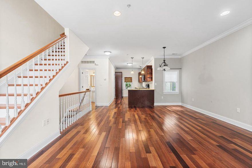 A spacious townhouse offering GARAGE parking, and a blend of modern elegance and comfortable living in a sought-after neighborhood. This impressive residence features three bedrooms, a versatile den, and two and a half bathrooms. You'll find the home to be deeper from front to back than most others, so it feels less vertical than the competition. Upon entering, you are greeted by a convenient garage with direct access to the lower level, which includes a flexible bonus room ideal for a family room, playroom, home office, or fitness area. Sliding patio doors lead to a private, fenced backyard, perfect for outdoor enjoyment. The main living level showcases an open and airy layout, highlighted by a spacious kitchen equipped with stainless steel appliances, quartz countertops, a large pantry, and a breakfast bar. The kitchen seamlessly flows into the expansive living and dining area, boasting abundant natural light, soaring ceilings, and elegant wide-plank hardwood flooring in living/dining area and all bedrooms. The second floor hosts two well-proportioned bedrooms, a full bathroom, and a conveniently located laundry room with linen storage. You can feel the elbow room on each floor. The upper level is dedicated to the master suite, featuring a generously sized bedroom, a spa-like bathroom with an oversized shower and a standalone soaking tub, ample closet space, including his, hers, a linen closet, and a private balcony. This exceptional townhouse offers the convenience of garage parking and is ideally situated on the cusp of Pennsport and Queen Village. It provides easy access to the city and major thoroughfares like I-95. This is a remarkable opportunity to acquire a stunning and spacious home in a prime location.