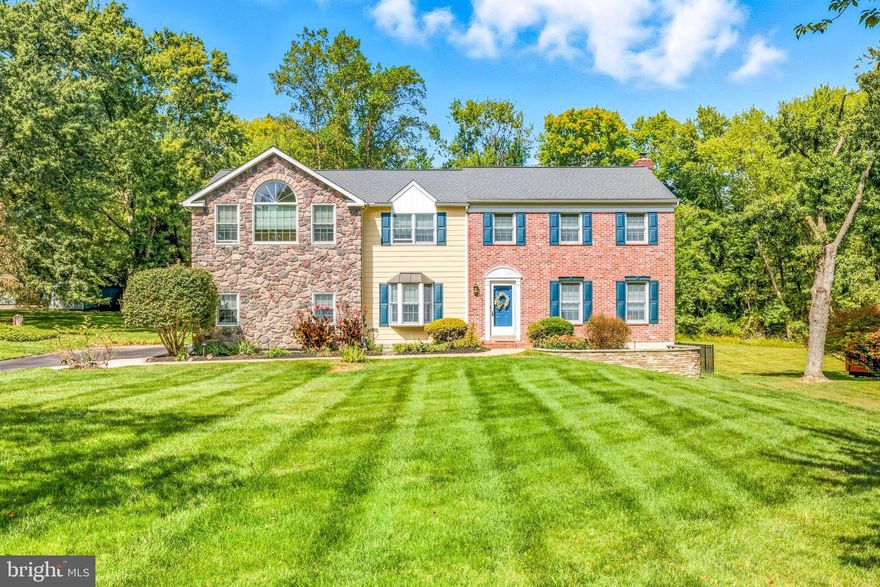 Welcome to your new Forever Home at 76 Colonial Circle!  Step into this charming brick & stone colonial nestled on a quiet cul-de-sac street in sought-after Garnet Valley Schools. Set on a generous 0.6 acre level lot, this 4-bedroom, 2.5-bath home offers the ideal blend of classic elegance and modern updates and is  ready for you to move right in. Enter through the center-hall foyer with hardwood floors that flow throughout most of the home, Formal living and dining rooms provide perfect spaces for entertaining. The updated kitchen shines with granite counters, center island, tile backsplash, and plenty of cabinet storage. The adjacent sunroom is the focal point of the first floor and features vaulted ceilings, a skylight, and sliders to the maintenance free deck overlooking the spacious, flat backyard — ideal for kids, pets, or weekend barbecues. The family room opens to the kitchen and offers a cozy brick fireplace and  access to the deck. As you head upstairs you’ll be blown away by the spacious master suite with siting room/office and a beautifully remodeled master bath with cavernous tile shower and handsome wood cabinetry. The sun-soaked primary bedroom with cathedral ceiling is truly exceptional with plenty of room for your king-sized bed, an abundance of closet space and a balcony overlooking the back yard. The second floor is completed by three additional bedrooms and an updated hall bath. A finished walk-out basement offers endless potential. Major updates include a newer roof and HVAC system giving you peace of mind for years to come. Location, location, location! Nestled in the heart of highly rated Garnet Valley School District (consistently A+ rated with top-tier academics and college prep). You're minutes from Thornbury Park and Concord Township Recreation Center, plus easy access to Costco, Concord Town Center, Brinton Lake shops and medical facilities, Longwood Gardens, Media, West Chester, tax-free Delaware shopping, and beaches. Your Home Sweet Home is calling!