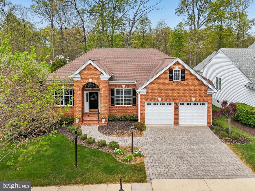 Get ready to LOVE where you live in this stunning and meticulously maintained Toll Brothers Tradition model in Haymarket's premiere, amenity-rich, active adult community, Regency at Dominion Valley! This 3 bedroom, 3 full bath beauty is calling your name with its incredible curb appeal and a floor plan that just makes sense. From the charming paver driveway and brick front stoop, step into a grand foyer that welcomes you into elegant formal living and dining rooms, complete with stylish trey ceilings, tasteful trim, and soaring 10ft ceilings that stretch across the entire main level. The expansive halls connect seamlessly to the extended family room, upgraded kitchen, and sunroom – all drenched in natural light and serving up jaw-dropping views of the 2nd fairway and the lush, well-manicured backyard! Gleaming hardwood floors flow throughout the main level. Your primary bedroom is a true escape, featuring a trey ceiling and an upgraded bath with a dual vanity and separate tub and shower. The gorgeous kitchen is a chef's dream with top-of-the-line cabinetry, granite countertops, tile backsplash, and stainless-steel appliances flows easily into the Sunroom extension.  A generous main-level 2nd Bedroom and remodeled Full bath round out the main level.  Continue downstairs to the fully finished light-filled lower level is perfect for hosting guests offering a huge 3rd bedroom (with tray ceiling, sitting room, and walk-in closet), remodeled full bath (including granite top vanity and marble floors), a cozy gas fireplace, and a full wet bar/kitchen complete with disposal, dishwasher, microwave and beverage fridge. Ready to soak up the outdoors? Head out to your huge updated (2023) deck with low-maintenance composite decking and vinyl rails with stairs leading down to a large patio and lush backyard. Recent updates galore include a remodeled main bath (2025), new hardwood floors (2025) and plush new carpet in the lower level (2025), fresh neutral paint (2024/2025), new washer/dryer (2025), a convenient laundry sink and upper cabinets (2025), elegant new garage doors (2024), new HVAC (2024), newer roof (2018) and water heater (2021) mean you can kick back and relax from day one! Don't miss this incredible opportunity to live the good life!