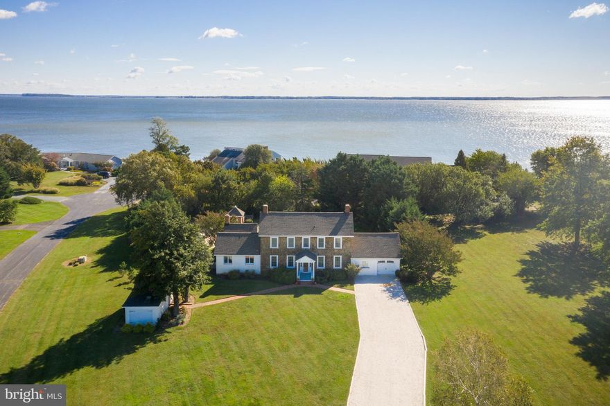 Charming casual elegance will greet you the moment you pull into the driveway of this 1811 Farmhouse. Care and consideration to maintain the character and history of the original pine floors and magnificent moldings and doors! Delivering on modern updates that capture an inviting coastal pottery barn feel.  The Kitchen includes granite, stainless, 2 sinks, bar seating as well as room for a large farmhouse table to sit on top of the rustic brick floors. Year-round comfort awaits you with 3 fireplaces, breathtaking hardscape stonework around the fire pit, pool, a pergola-covered outdoor kitchen, golf, wildlife, and bayside seating at your personal pier with a boat lift. The in-ground pool is enveloped with significant landscaped additions to provide privacy around the entire recreational area. The home is complete with a first floor primary bedroom with FP, two 2nd floor guest BR's with a shared full bath, and a fourth detached carriage house with a dedicated eat-in area, & a private full bath. Enjoy relaxing in your large screened porch while contemplating whether to stroll down to the new pier & boat lift to have fun on the Eastern Bay,  head out to enjoy the golf course, or maybe it's time to enjoy a gorgeous sunset! So many options for you to enjoy either for full-time or seasonal living on Kent Island.