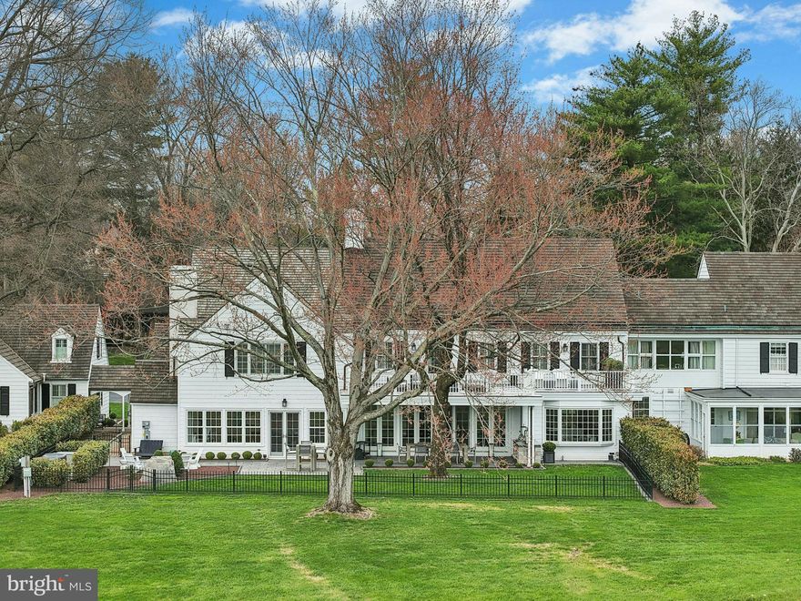 This may be the best home you have ever seen…..On a private road in a world-class neighborhood, surrounded by mature trees and manicured lawn, this exceptional home has panoramic views over 22 acres of meticulously tended grounds, within walking distance to the Weyhill Golf Course of the Saucon Valley Country Club. This noteworthy property, in coveted “Old Weyhill”, is part of an exclusive eight home enclave that is reminiscent of a New England village green.
Weyhill Circle boasts every amenity one would expect, with a newly remodeled and gracious design. Beautifully redone, with sophisticated additions, there are walls of windows in every room to frame the pastoral and protected vistas. Breathtaking at entrance, an expansive coffered-ceilinged living room is sun-filled with a wonderful flow for entertaining, opening to a stunning covered porch and outdoor kitchen, beautifully landscaped with sunset views. Adjacent, the enormous family room, also with coffered ceiling, boasts a bar, second fireplace, built-in bookcases and a south-facing wall with charming window seats.  An extraordinary and expansive kitchen offers high-end appliances, newly opened to an inviting dining room. Throughout, attention to detail is evident in the custom built-ins and bookcases, crown moldings and fabulous windows, with multiple doors beckoning one outside. Hardwood floors enhance every room, on every floor, while an elevator accesses three levels.
The sumptuous, new primary suite will delight and impress.  A generous primary office opens to a cathedral-ceilinged master bedroom with fireplace, walls of windows and full house deck with incredible long-distance vistas. The elegant primary bath, with dressing room and custom walk-in closet, will soothe and pamper.  Three additional bedrooms, laundry and 2 baths complete the second floor.  A wonderful bonus, the third floor offers an additional family room.
On the lower level, a custom designed wine cellar is adjacent to the elevator, for easy access. There is a work area with a quarter bath and 2025 custom cabinetry. A 20 KW generator and HIK Connect technology offer peace of mind. The new, oversized three car garage has a special alcove for your Golf Cart …. available with SVCC approval.
Weyhill Circle invites one to linger and enjoy the beauty of this environment, in a privileged position amidst a 22 acre piece of paradise …. all within the private roads of the Saucon Valley Country Club.  Rarely does a home offer such sophisticated ease of living, in a premiere location, surrounded by an outside environment that invites you, daily, to walk the acreage and private roads.  On the bluestone patio, overlooking bucolic views, the everyday backdrop includes wildlife by day and a brilliant umbrella of stars by night.  Here, worry-free luxurious living exists in a location that rarely becomes available, in a setting that is one of Saucon Valley’s best.