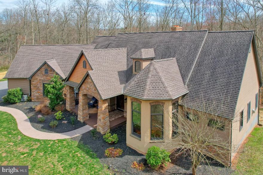 Just a short walk to MT GRETNA with over 10 acres, This Unique Custom home built by Zimmerman Builders has over 5000ft of finished space and enough garage space for 7- 8 cars (owner had 9 cars in garage space- 5 up top and 4 in basement garage).  This 4 bedroom home can easily be expanded to 6 bedrooms if needed.   Clean and green with mature forest, multiple springs and streams-Abuts both the LEBANON RAIL TRAIL and STATE GAME LANDS 145.   Covered decks and  patios overlook the grounds... The interior of this home is a must see- Chef's Kitchen, Impressive Primary Suite with steam shower, home office, huge living areas, sunroom are all on the main floor.  The second floor has 3 nice sized bedrooms and a full bath. The lower level has a full bath, 2 rooms that could easily be converted to bedrooms, open space and another garage.   The main level garage has 3 doors and enough space to tandem park 5 cars.  This property has 3 working fireplaces ( wood, gas, and high efficiency wood stove).   
In preparation for the sale, the owner has installed a new heat pump water heater, new water softener, high efficiency wood stove, serviced the geothermal heating system, and serviced the steam shower. 
THIS home is a MUST SEE and MOVE IN READY...